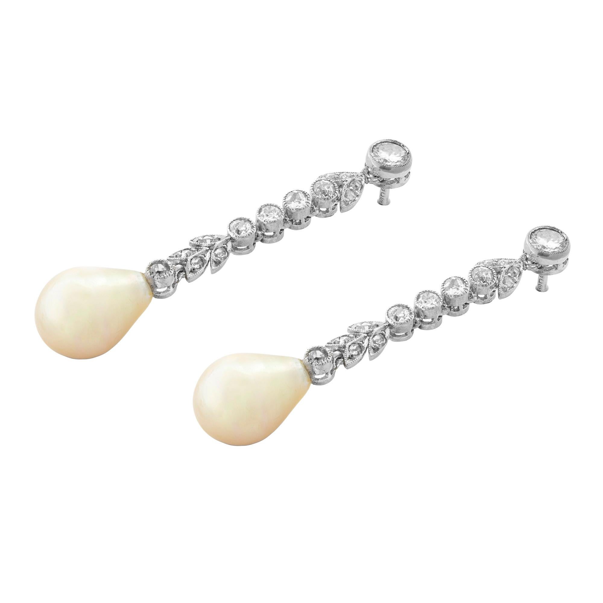 A pair of Edwardian pearl and diamond drop earrings, the natural saltwater drop shape pearls measuring approximately 11 x 8.3mm and weighing 4.28 and 4.73 carats, accompanied by a Gem & Pearl Laboratory certificate, suspended from an old- and