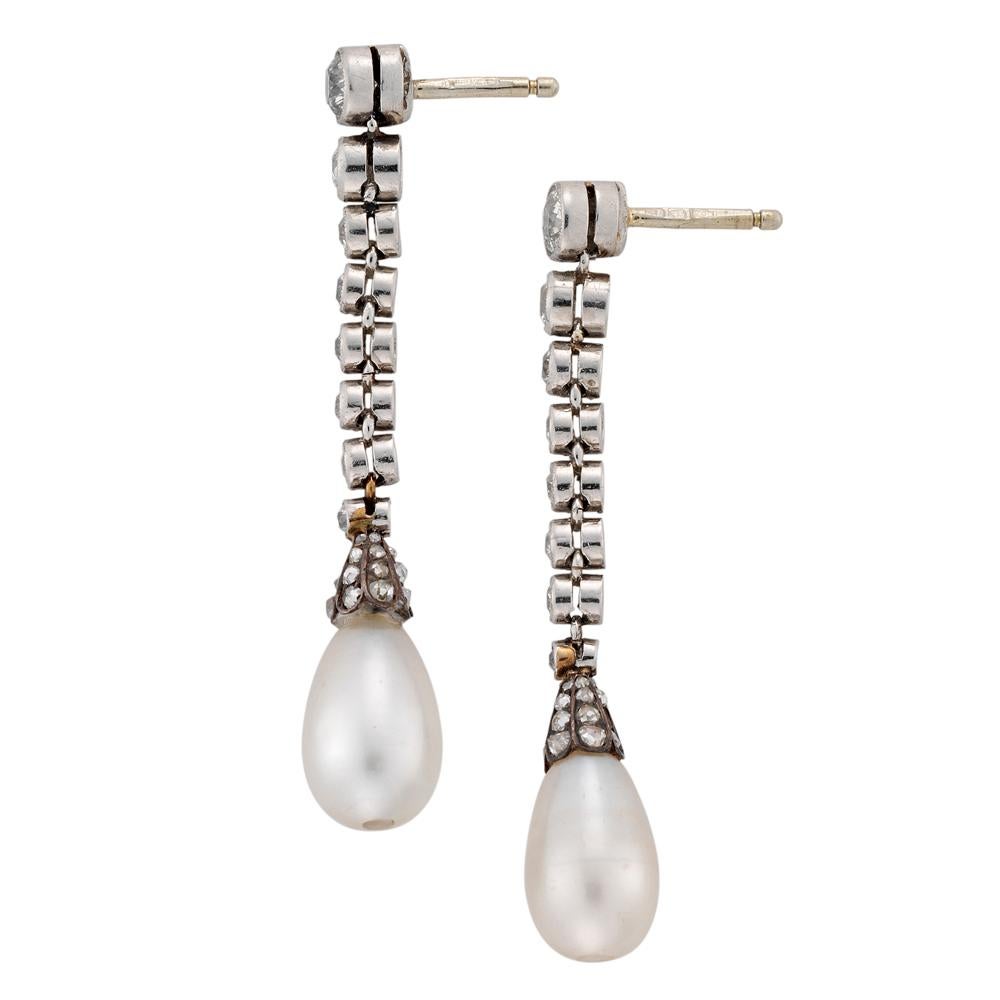 A pair of Edwardian pearl and diamond drop earrings, each earring a run of eight old brilliant-cut  diamonds estimated to weigh a total of 1 carat, each millegrain rubover-set in platinum collets, graduating to the base, suspending a tear-drop