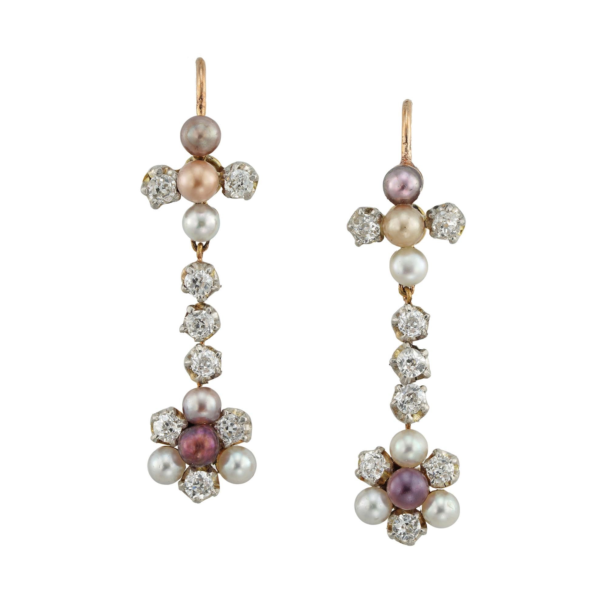 A pair of Edwardian pearl and diamond earrings, each top bearing a cross, vertically set with three pearls and two old-cut diamond set arms, suspending a diamond-set run, suspending a pearl and diamond set cluster, the multicolored pearls