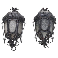 A pair of elaborate Italian wrought iron hanging lanterns C 1920.