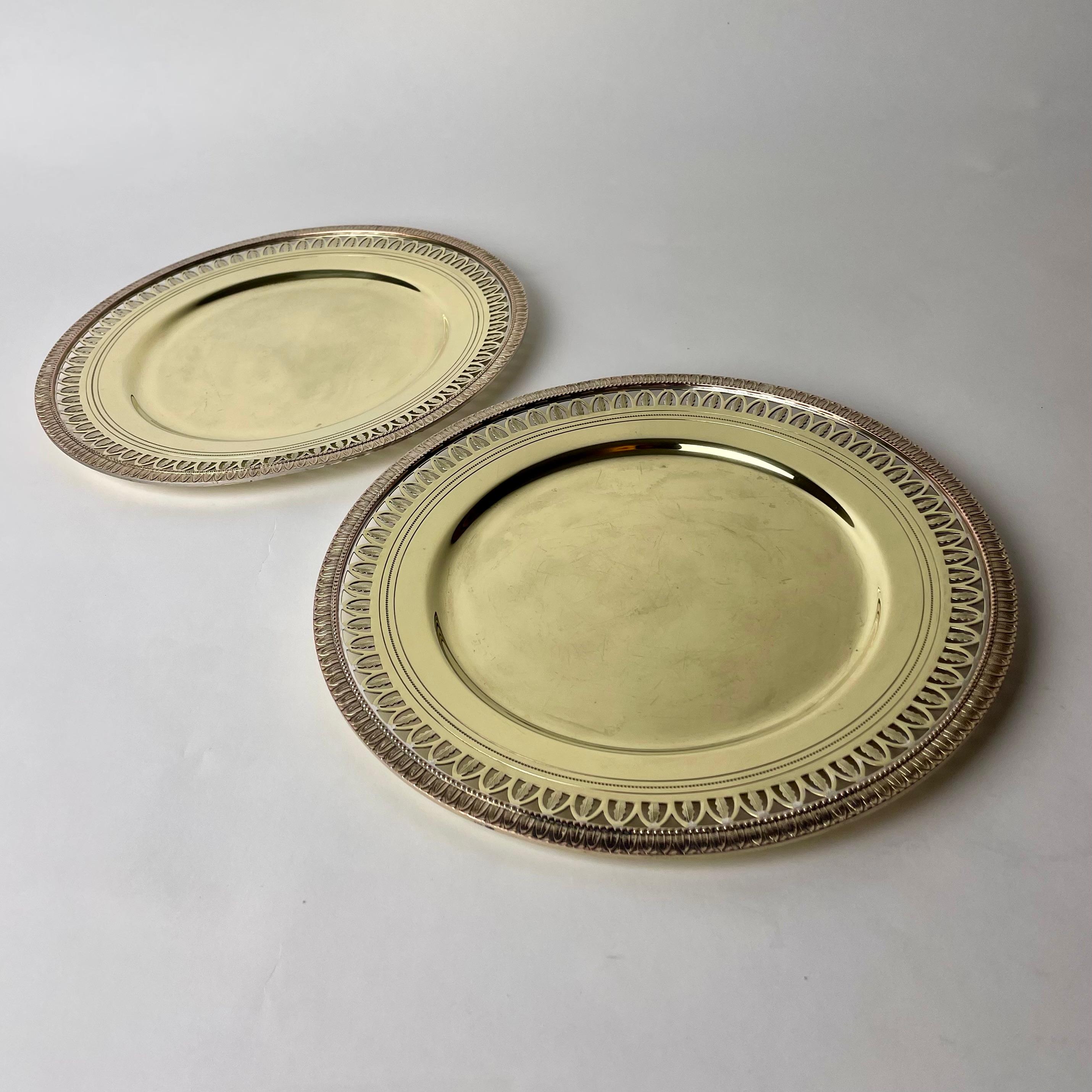 A pair of Elegant brass Platters in Empire style probably from the late 19th Century or early 20th Century. Beautiful empire decorations with openwork edge.

Wear consistent with age and use 