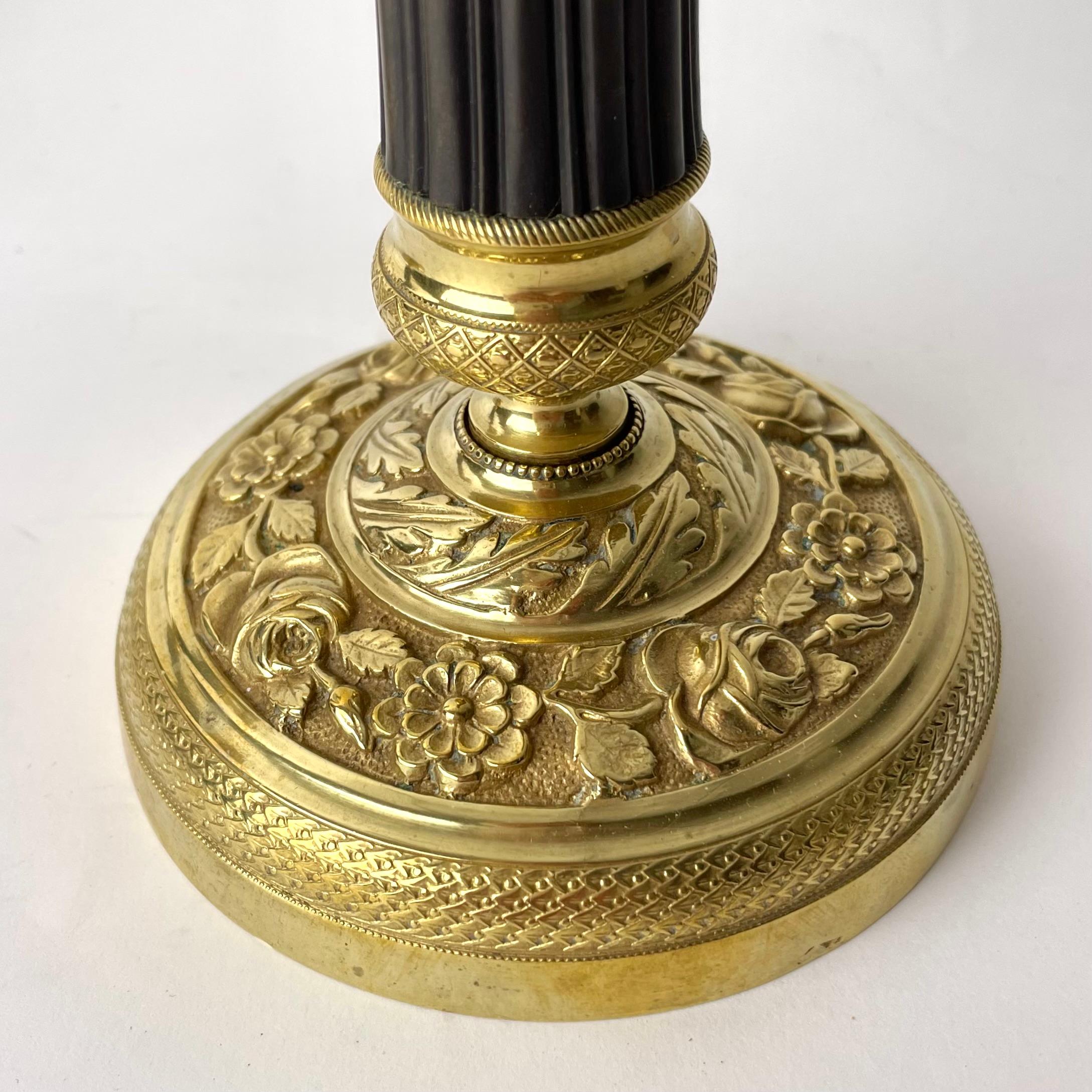 Gilt A Pair of Elegant Empire Candlesticks, Gilded and Patinated Brass, 1820s France For Sale