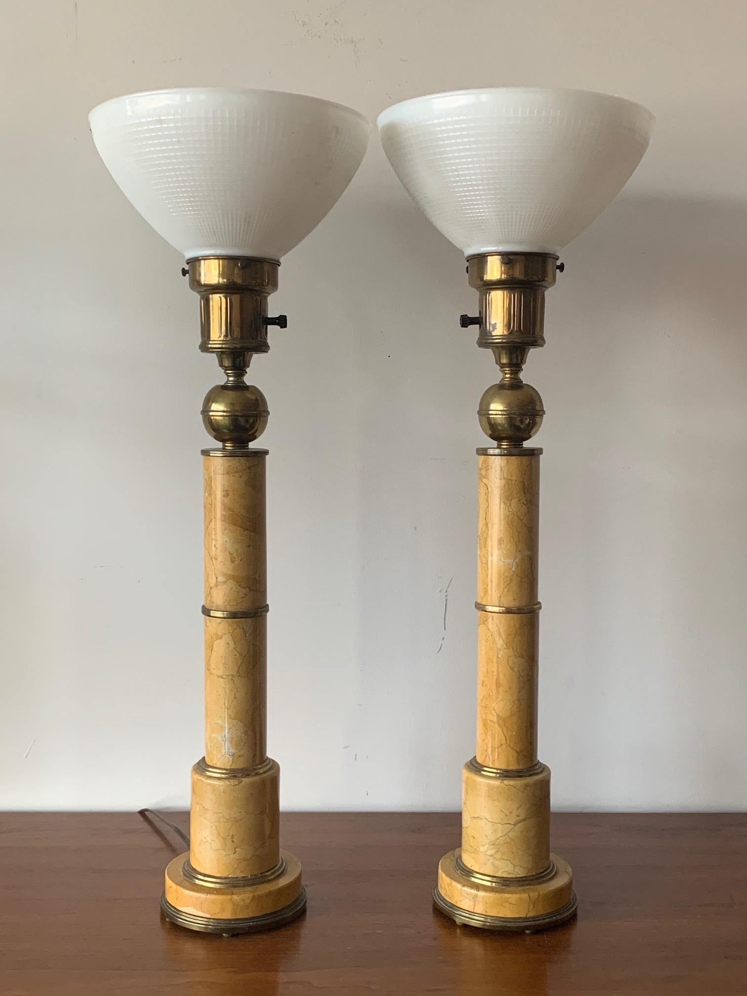 A pair of elegant Italian marble lamps circa 1950s. Very heavy with bronze mounts and brass details these lamps are exceptional and will fit in a variety of interiors-from modern to traditional.
