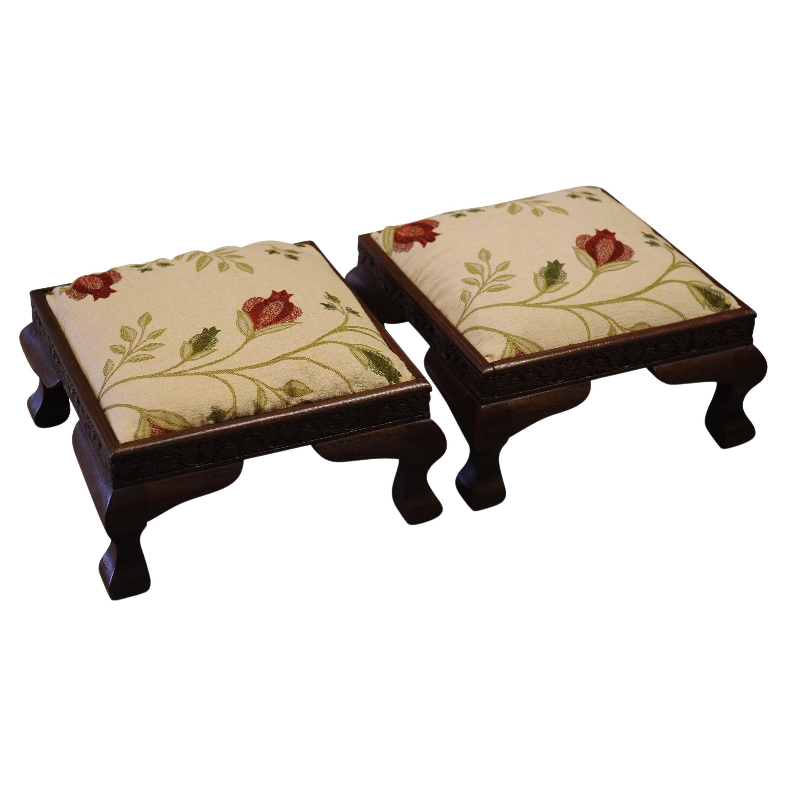 A Lovely Matching Pair of Victorian Floral Embroidered Low Footstools With Wood Carved Bases Set On Four Foot Pads.