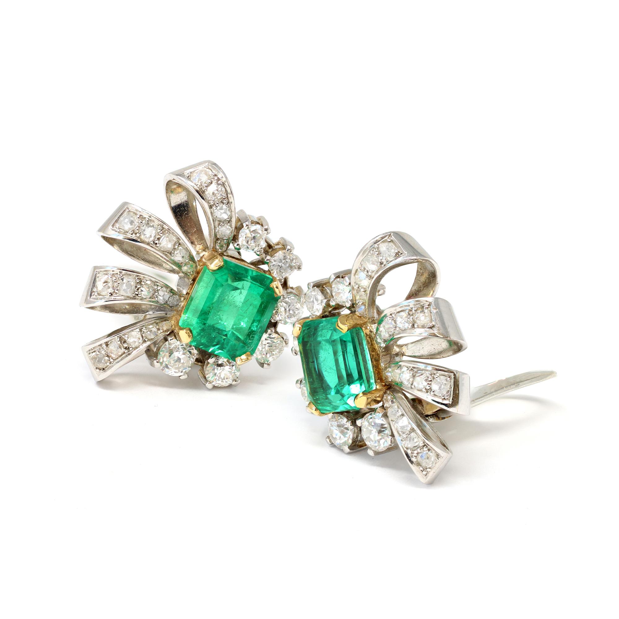 A pair of Brazilian Emeralds and Diamonds earrings set in platinum. Circa 1940s, each of the  earrings features a square-cut Emerald, surrounded by diamonds. The  well matched Emeralds have an combined weight of 6.34 carats, they are accompanied by