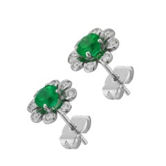A pair of emerald and diamond flower cluster earrings