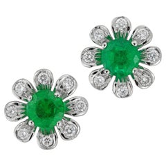 A pair of emerald and diamond flower cluster earrings