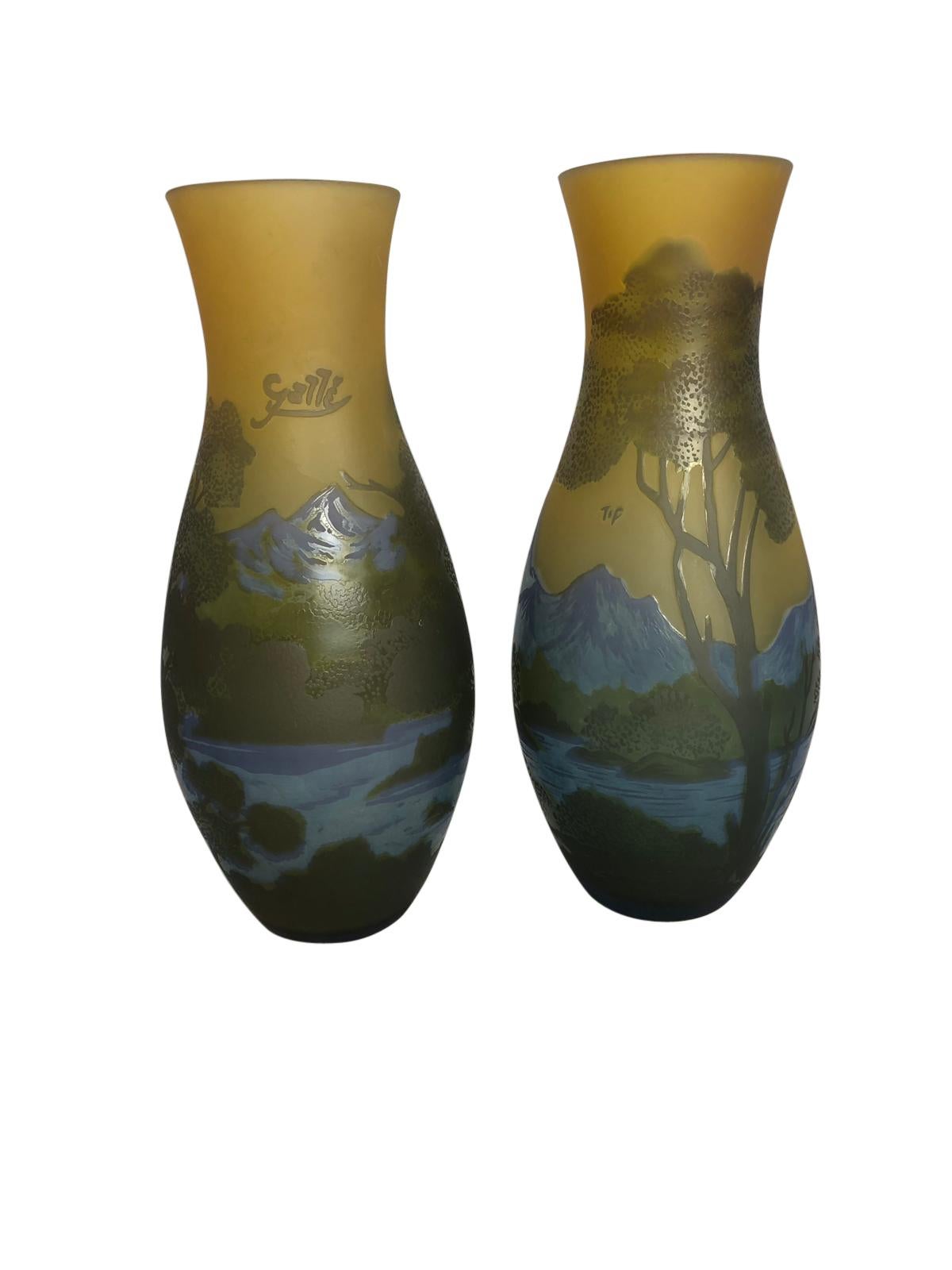 A beautiful pair of Emile Galle-style cameo-cut glass vases, 20th century. In “Mountain Lake” decor, signed at one side “Galle”, in wavy script within a freeform reserve.