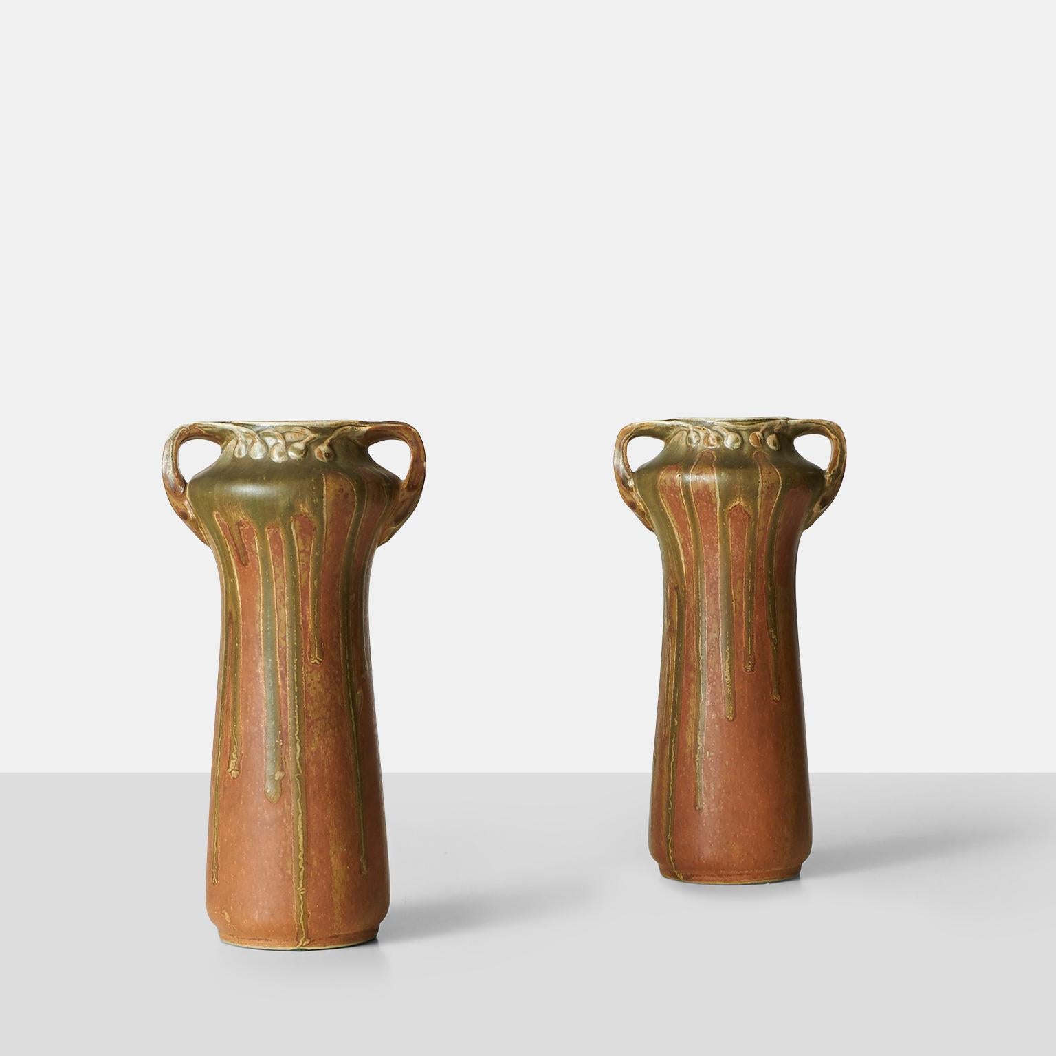 A pair of French art nouveau vases of earthenware modeled with two handles. Decorated with glazes in shades of brown. Marked Guillaume
