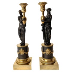 Pair of Empire Candlesticks in Gilded and Patinated Bronze. Early 19th Century