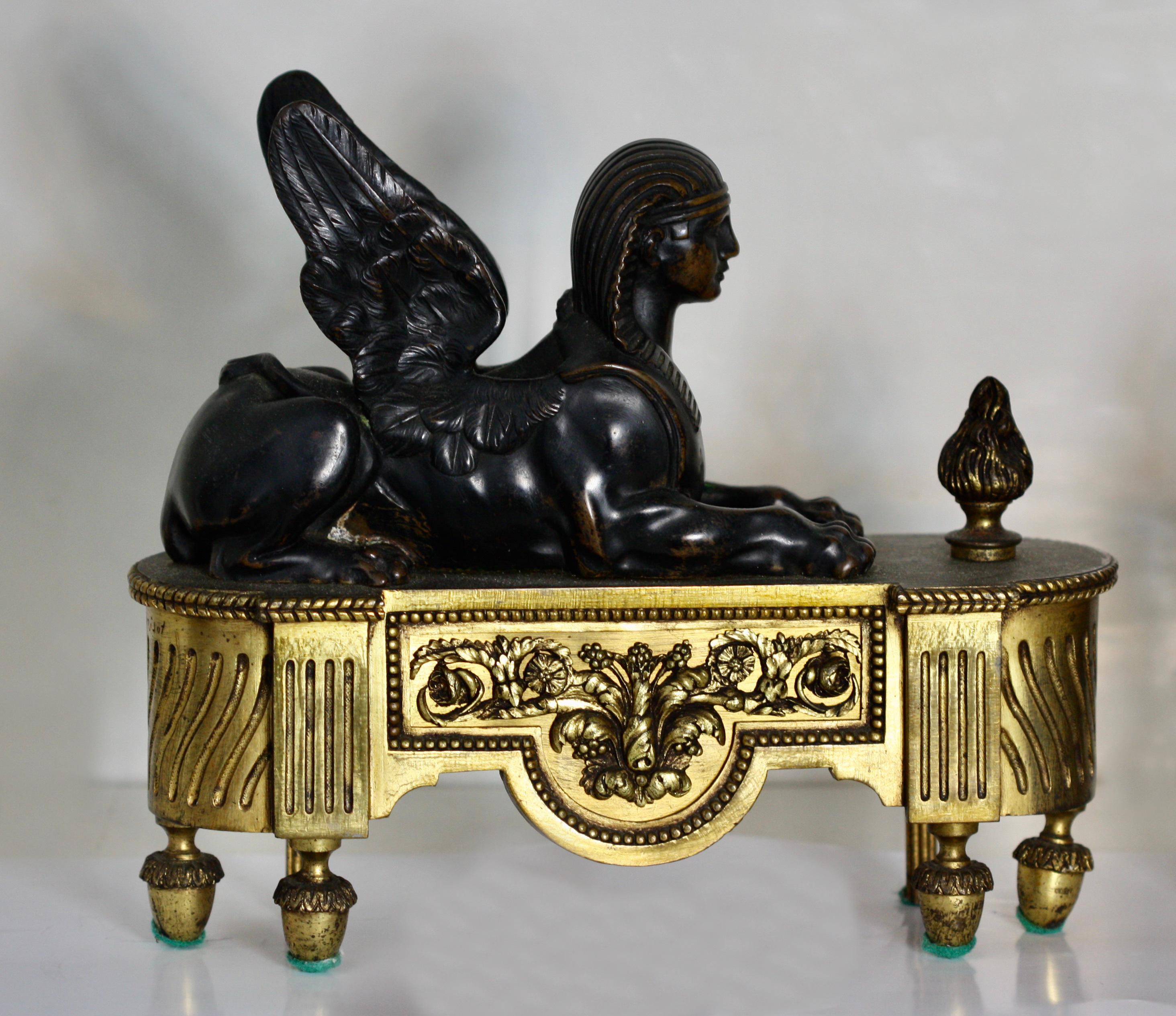 A pair of Empire gilt and patinated bronze chenets,
French, 18th century
each with a winged sphinx raised on a rectangular base with curved ends on acorn feet.
Measures: Height 10.25 in. (26.03 cm.), width 11.5 in. (29.21 cm.), depth 3.5 in.