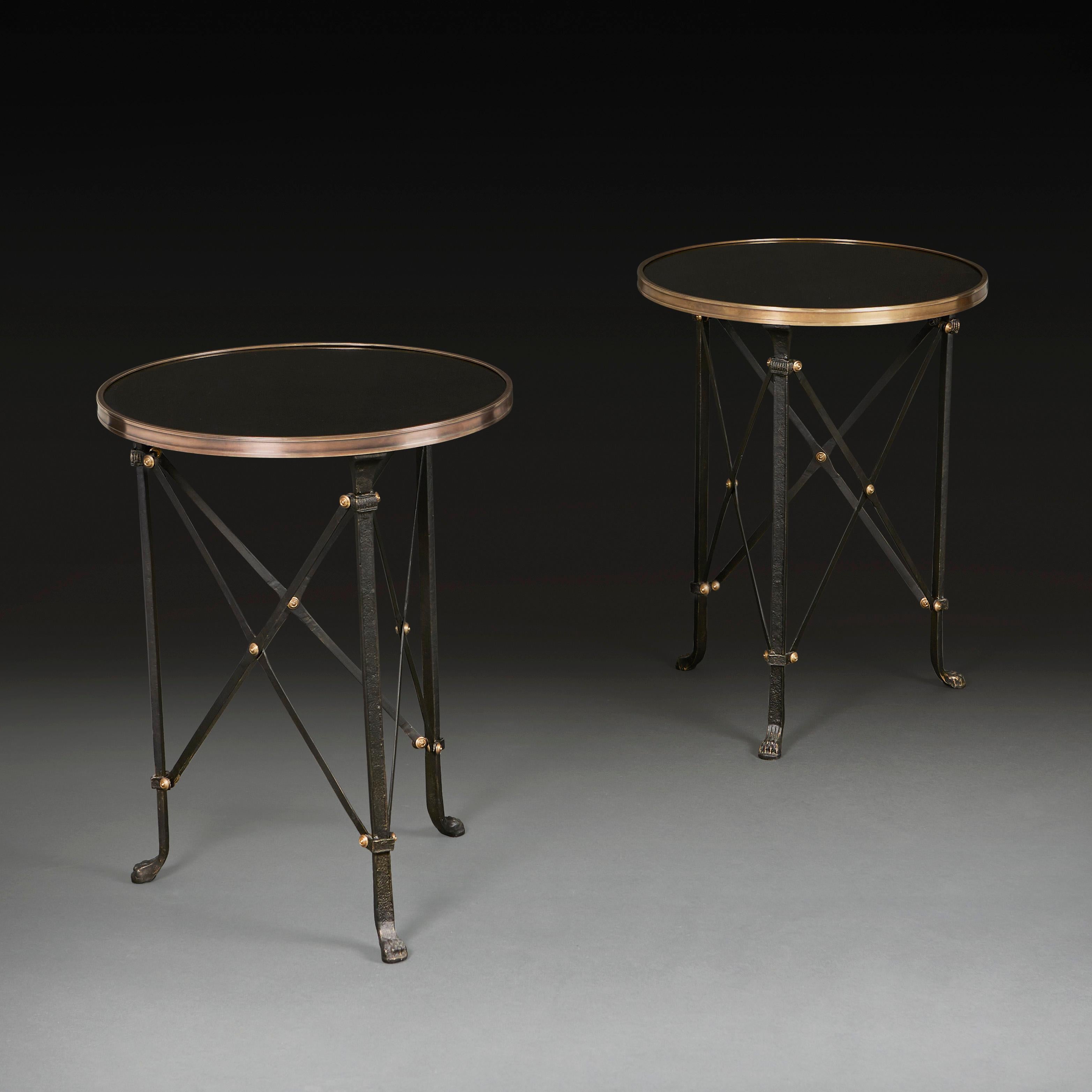France, 20th century

A pair of mid twentieth century Empire style circular gueridon,  the black marble tops with polished brass rims, all supported on tripod bronze bases with cross stretchers and brass roundels, the legs terminating in hairy paw