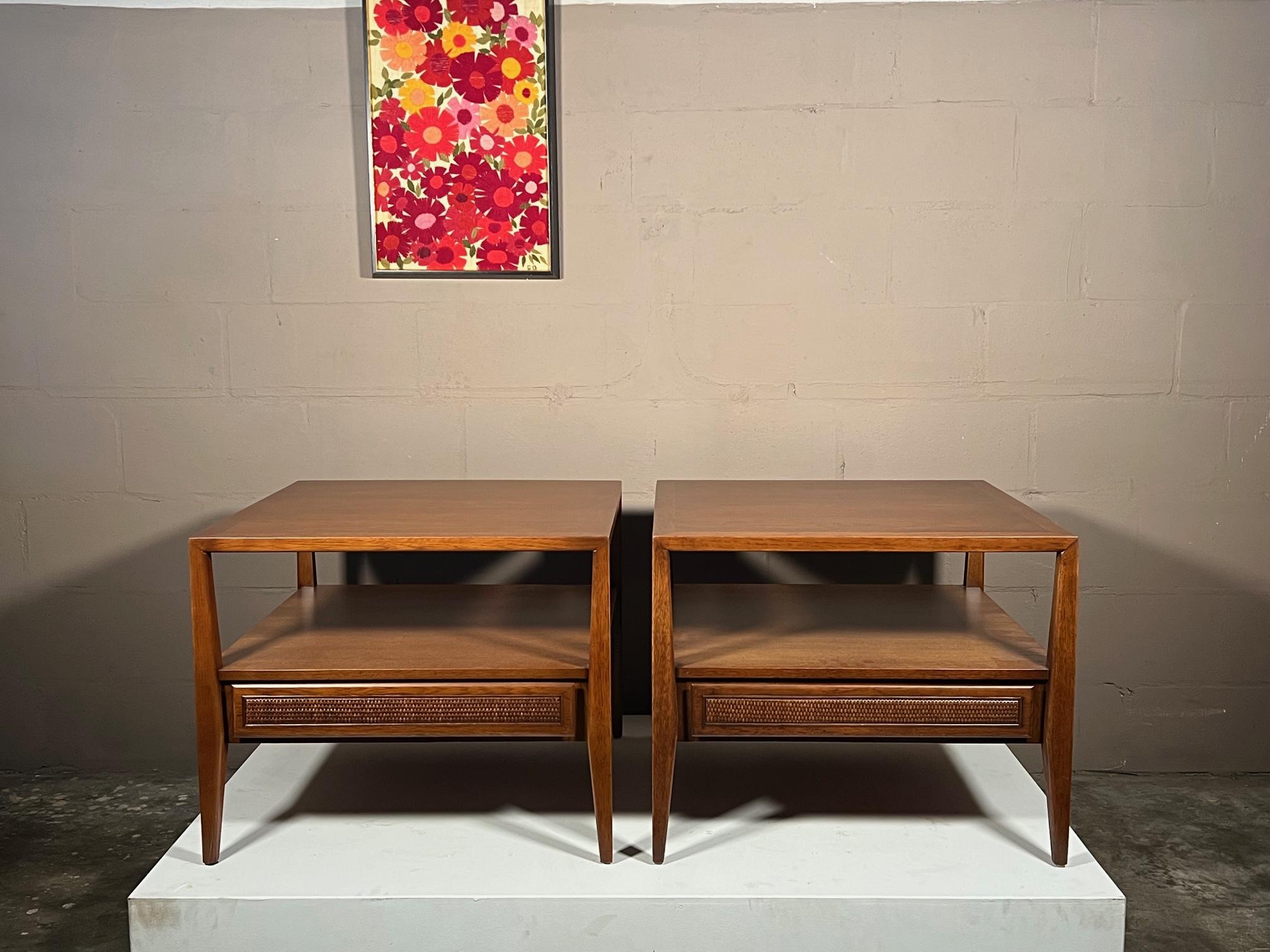 A great pair of large scale end tables or night stands by esteemed Century Furniture, ca' 1960's. Unusual tapering legs in the style of Gio Ponti, finished on the back, with open space and single drawer.