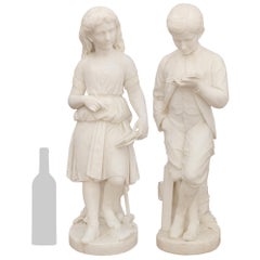 A pair of English 19th century white Carrara marble statues, signed George Halse