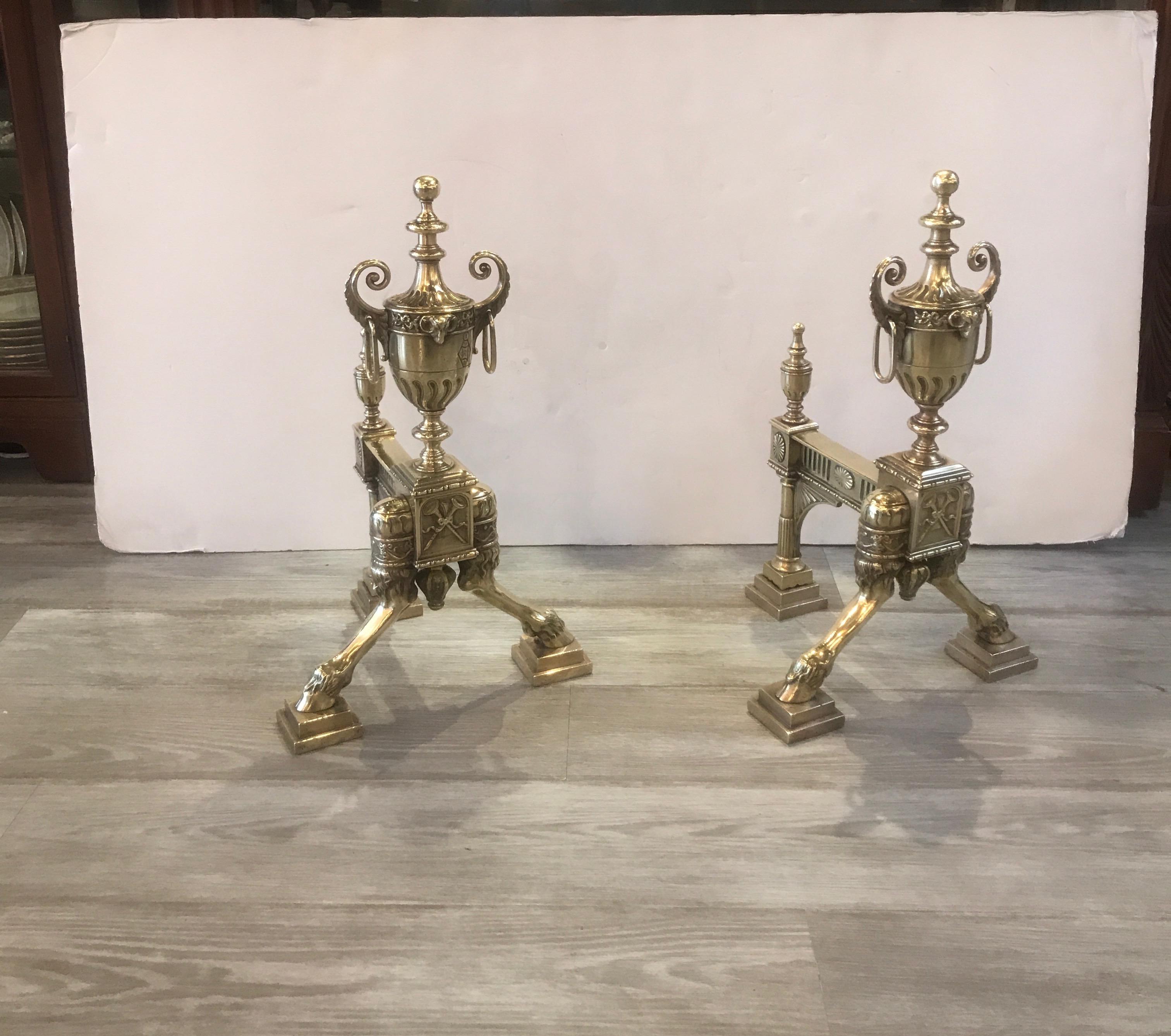 Elegant pair of polished cast bronze chenet andirons. The solid bronze with urn tops with front paw feet and beautifully detailed back legs. Clearly marked with English registry mark showing the date of September 21, 1882.