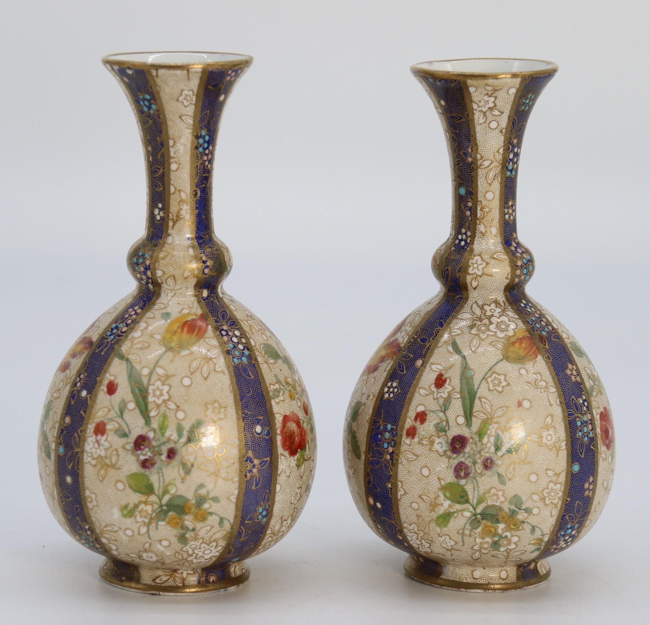 This most unusual pair of delicately decorated early Carlton Ware vases was made at the English Stoke on Trent factory.  These pleasing vases are of a rare pattern and one that I have never seen before. They have a bulbous form with a shaped tall
