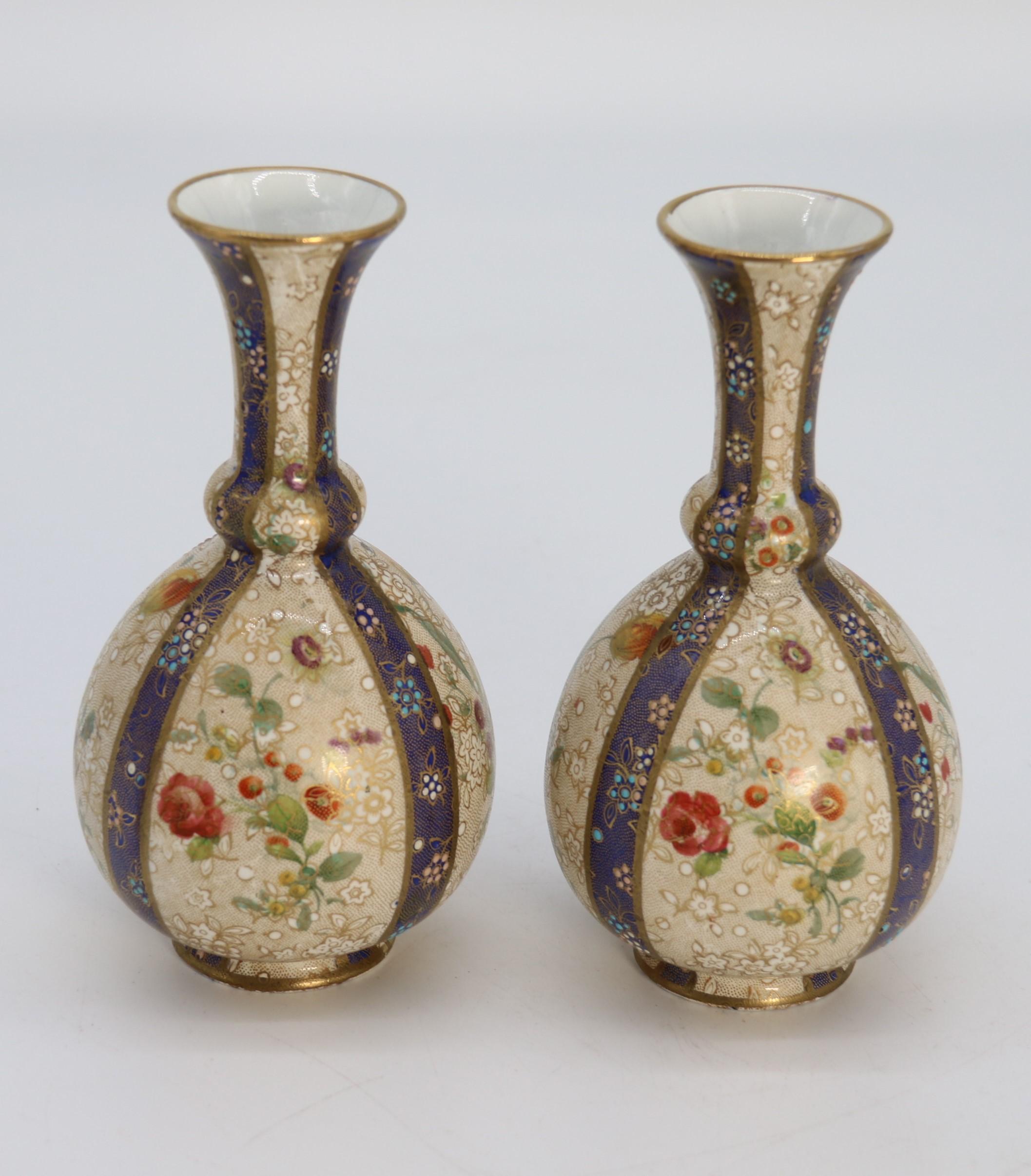 Porcelain A pair of English early Carlton Ware enamelled and gilt floral vases, circa 1900