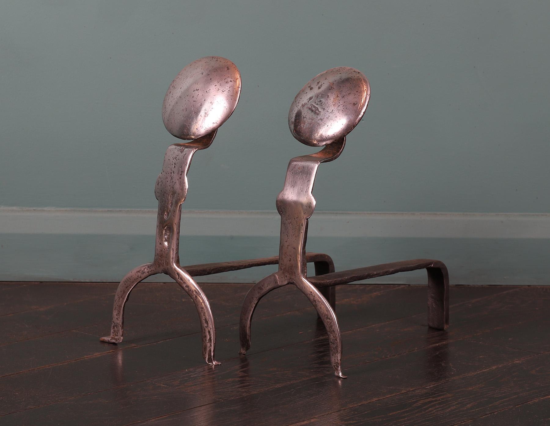 A pair of English 18th century polished steel andirons with circular discs on arched supports. Black iron log supports to rear. Losses to feet. Restored.
Circa 1790