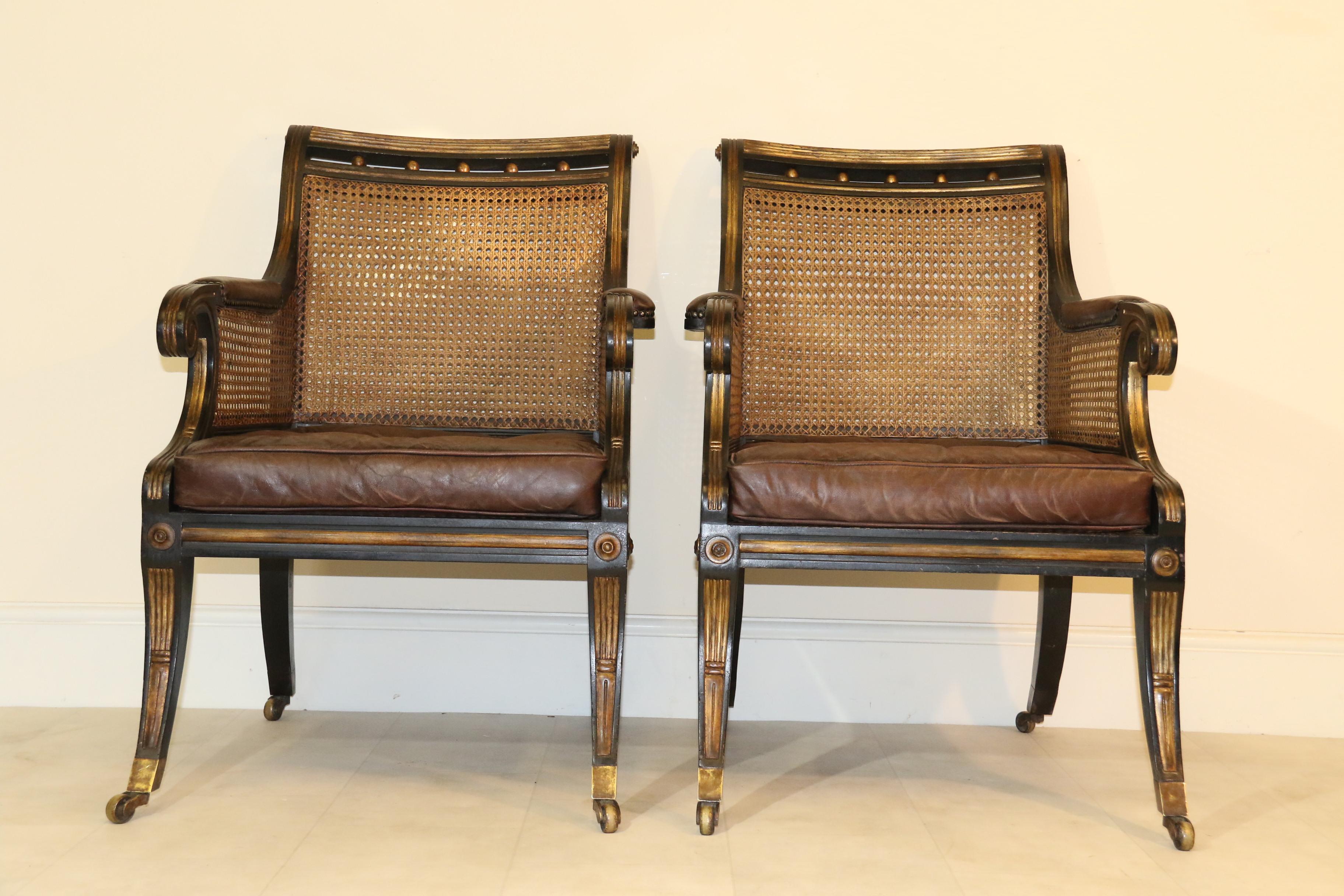 A very stylish pair of fine quality early 20th century Regency style ebonized and gilt library chairs. These superb early 20th century chairs are copies of very elegant Regency examples. They are correct in every detail and have been made in a good