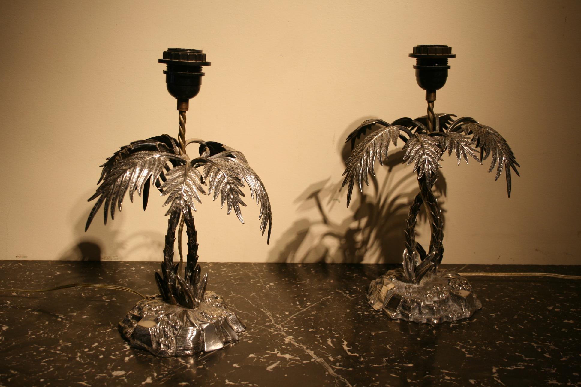 A lovely pair of silver plated lamps in the form of 2 intertwining palm trees, both carrying English silver plate marks and originating from the early 20th century.