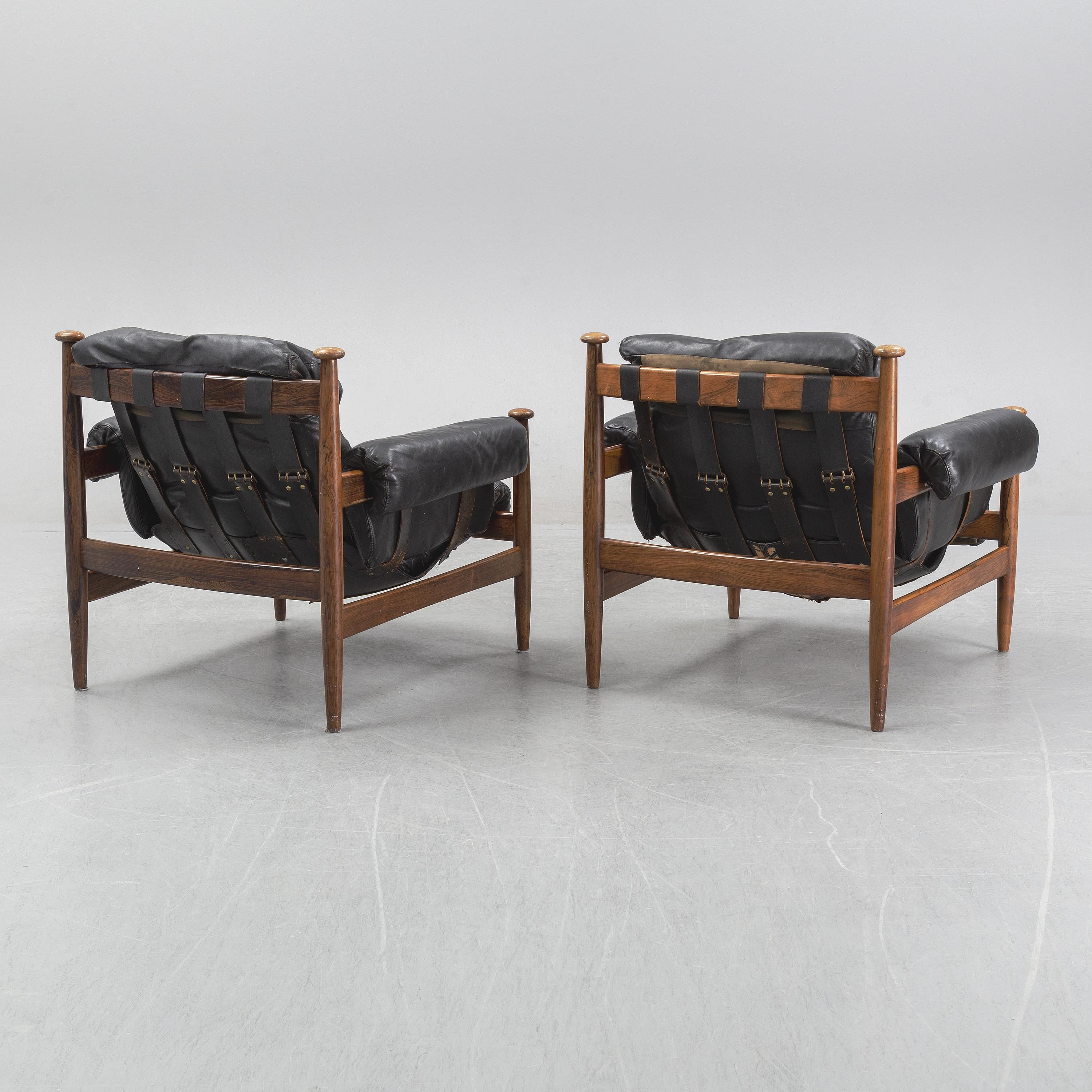 
'Armiral' easy chair designed by Eric Merthen for Ire Mobel Sweden in the 1960s. The chair has a beautiful rosewood frame and is upholstered in the original black leather. The cushion is supported by leather straps with brass details. Remains in