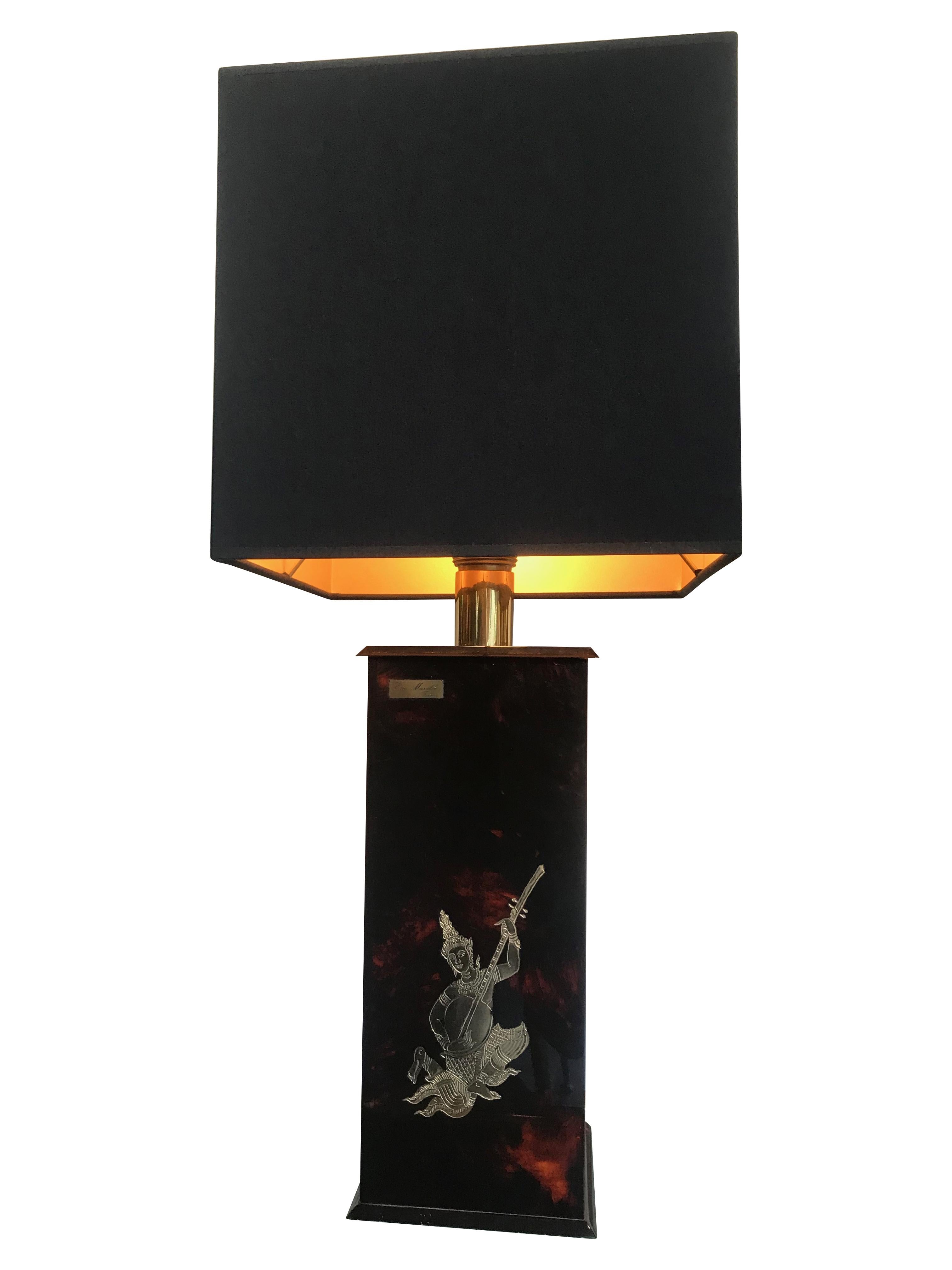 A pair of Eric Maville faux tortoiseshell lamps with Thai sitar player motif in gilt metal on the front. Signed 