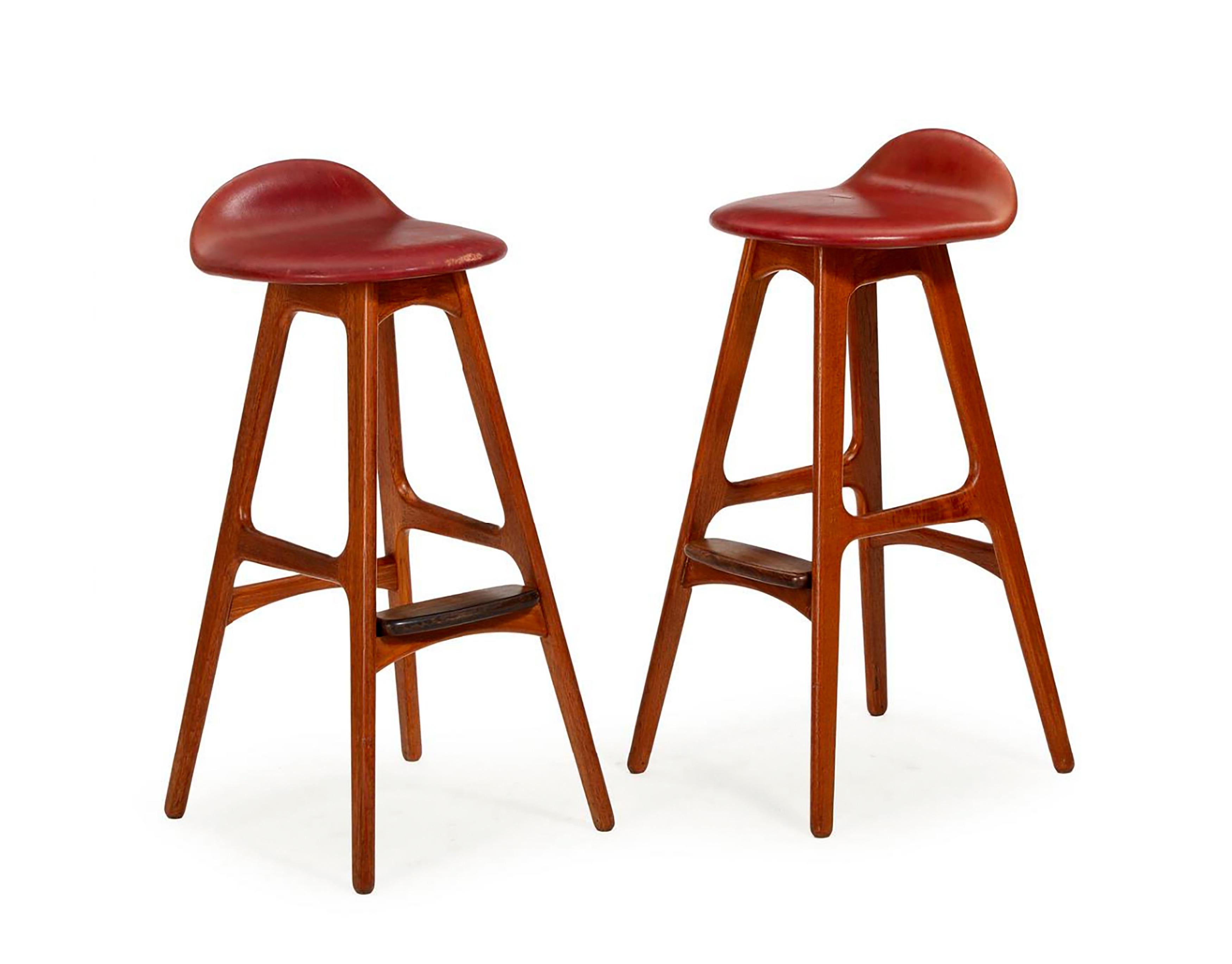 Rare bar stool by Erik Buch with solid hardwood frame with footrest, seat upholstered in red leather. Designed in 1965. Seat height 77cm. Set of two, price for both.