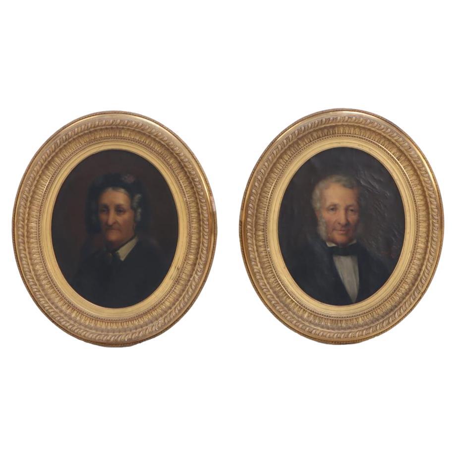 A pair of European School oil on canvas portrait paintings.
