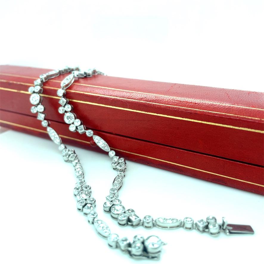 This one of a kind pair of Art Deco Cartier bracelets boasts numerous gorgeous old European and old mine cut diamonds weighing 12.00 carats total. Crafted with perfection in mind, each diamond is bezel set with fine milgrain detail and the links