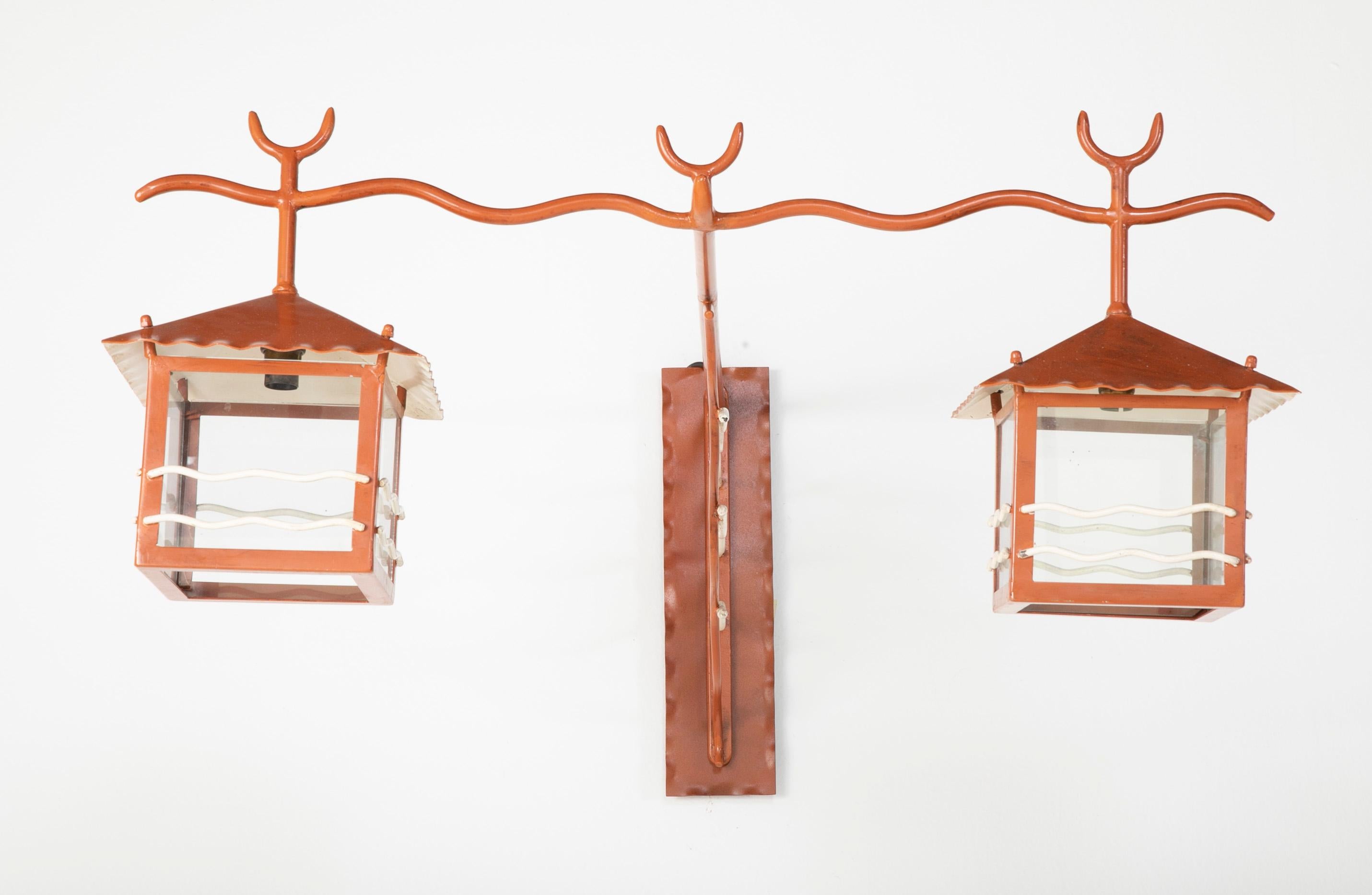 A very interesting large pair of French 1950s sconces. Painted handwrought iron. Scaled for outdoor or indoor use.