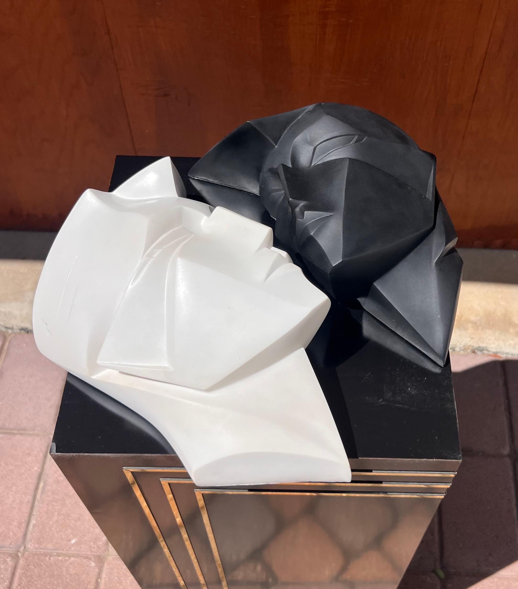 A pair of wall-mounted Art Deco revival sculptures - one black and one white - depicting two graphic and angular faces by Lindsey Balkweill, signed and dated, 1986. Great condition and ready to hang. 
Dimensions:
White: 8” W x 5” D x 12” H 
Black:
