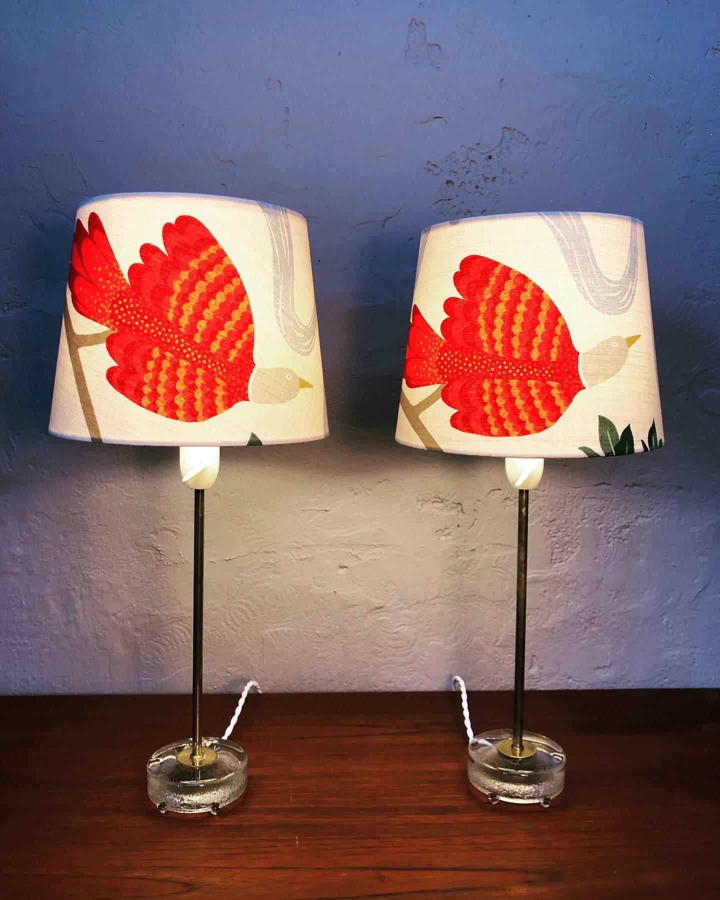 A pair of midcentury table lamps by Falkenberg lighting factory of Sweden. 
These gorgeous lamps are standing on a glass base and with a brass stem. 
The lamps still have their original bulb holders with an on/off switch and mounted with an