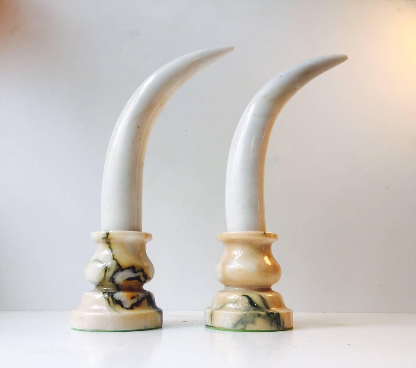 A pair of faux elephant tusk bookends or decorative ornaments for your desk, dresser or in front of your entrance hall mirror. They are constructed entirely of marble and are very heavy. Anonymous European maker, mid-late 20th century in the style