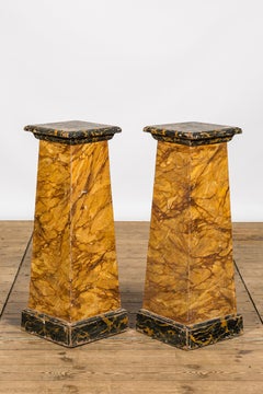 A pair of faux-marbre wooden pedestals