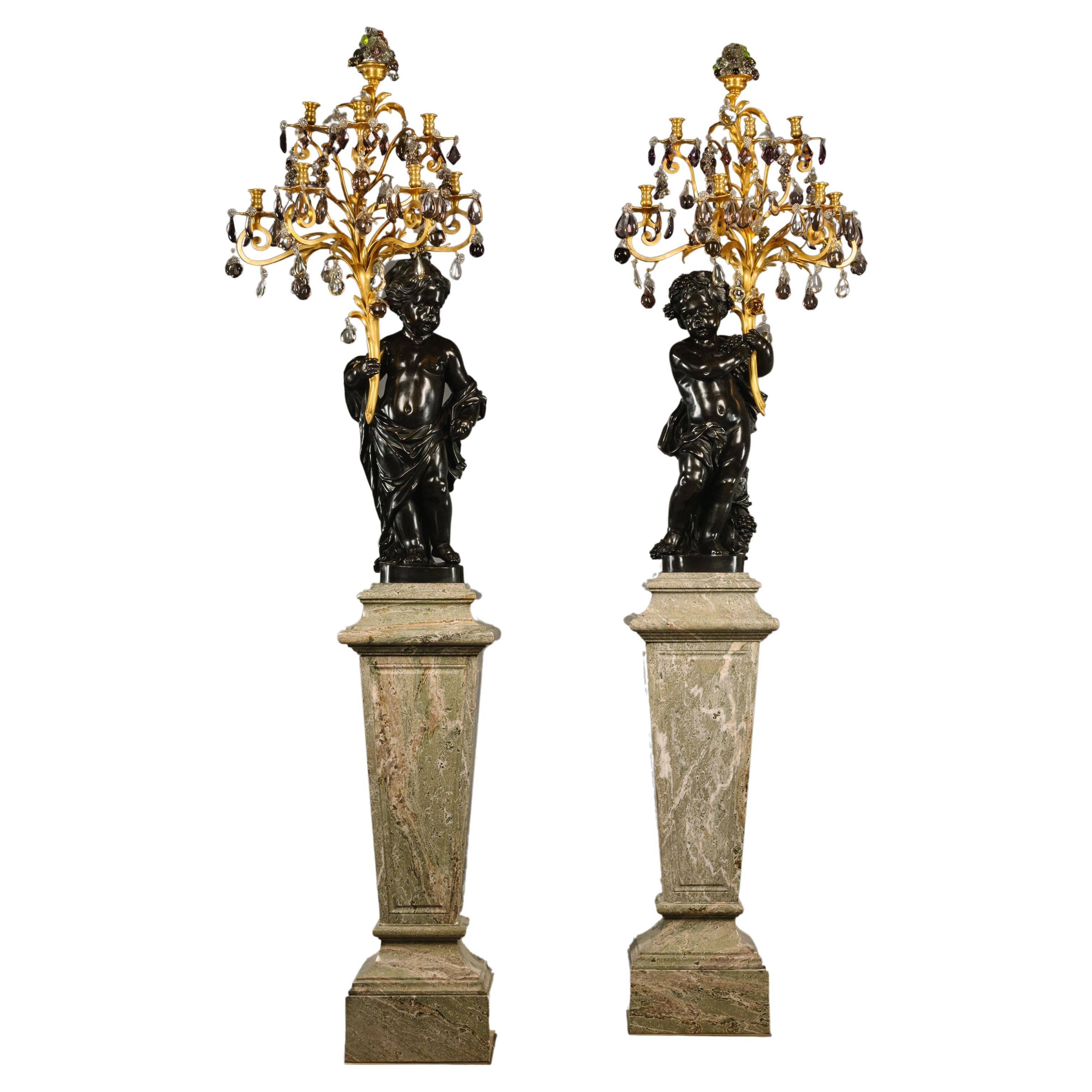 A Pair of Figural Putto Seven-Light Candelabra, On Green Marble Pedestals For Sale