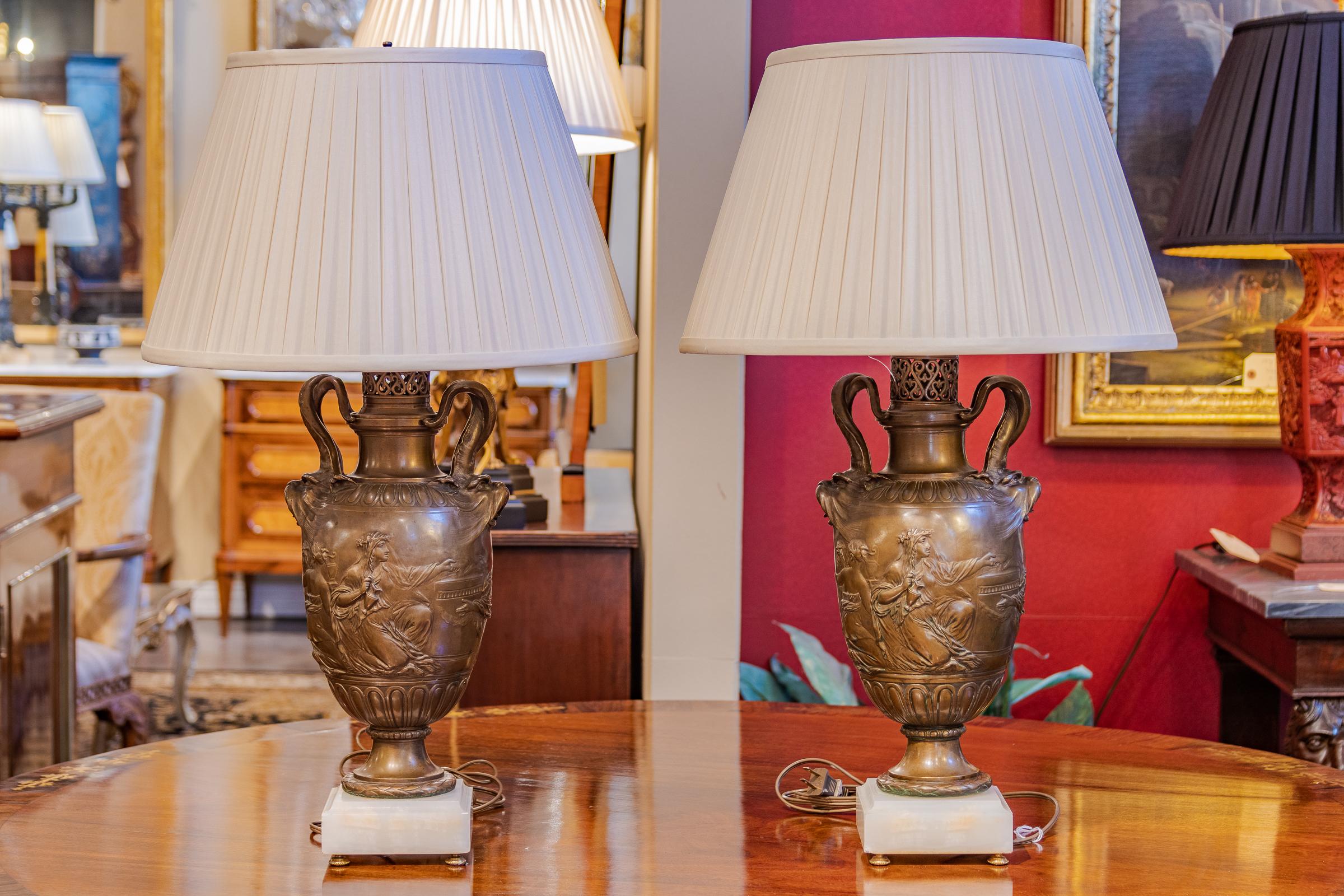 A pair of 19th century bronze patinated classical urns signed F. Barbedienne. Custom made into lamps.