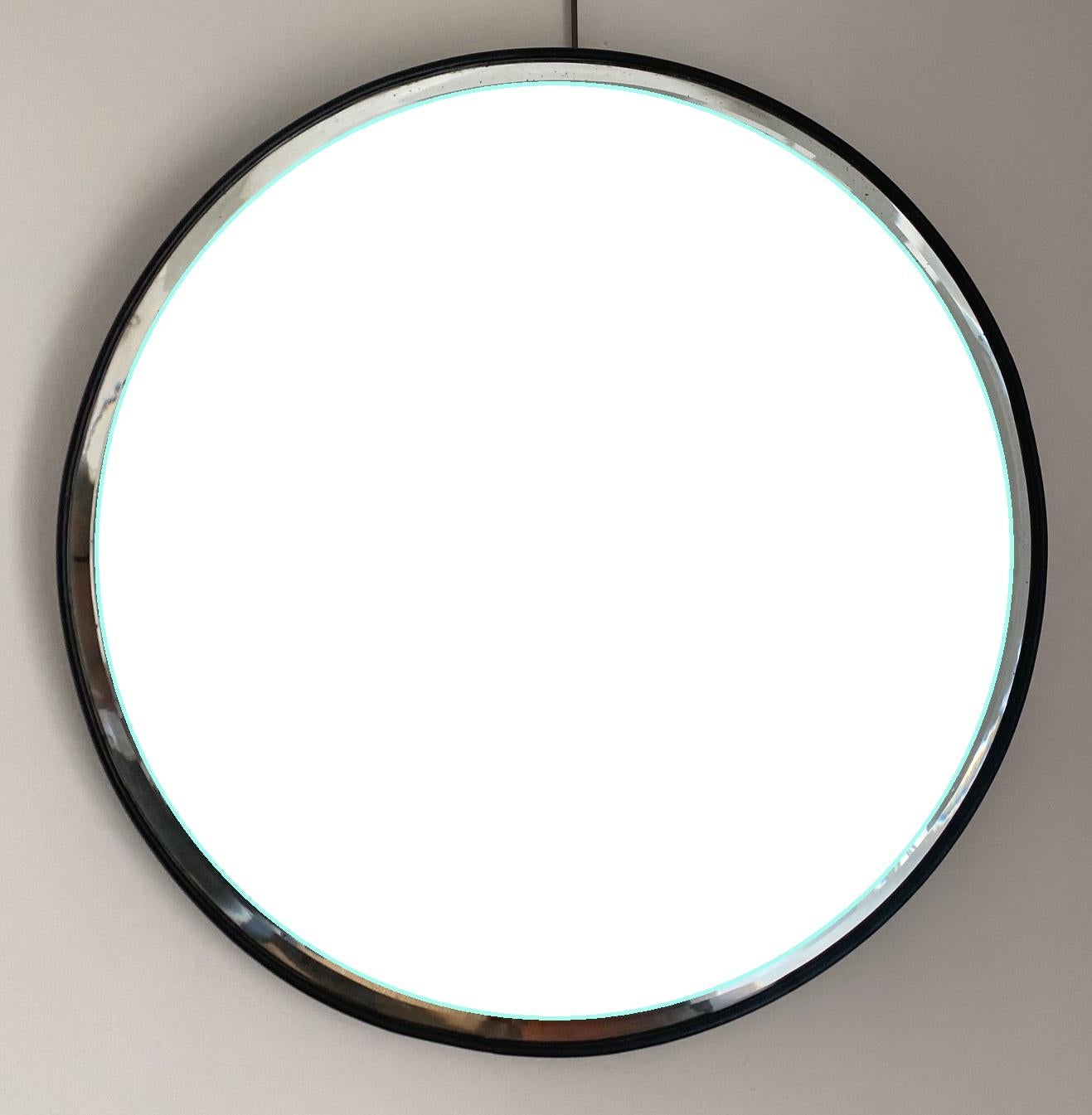 A pair of Art Deco 1930s circular mirrors with fine edged black frames showcasing original beveled glass plates, supported on an octagonal back structure of joined ebonized wood sections.