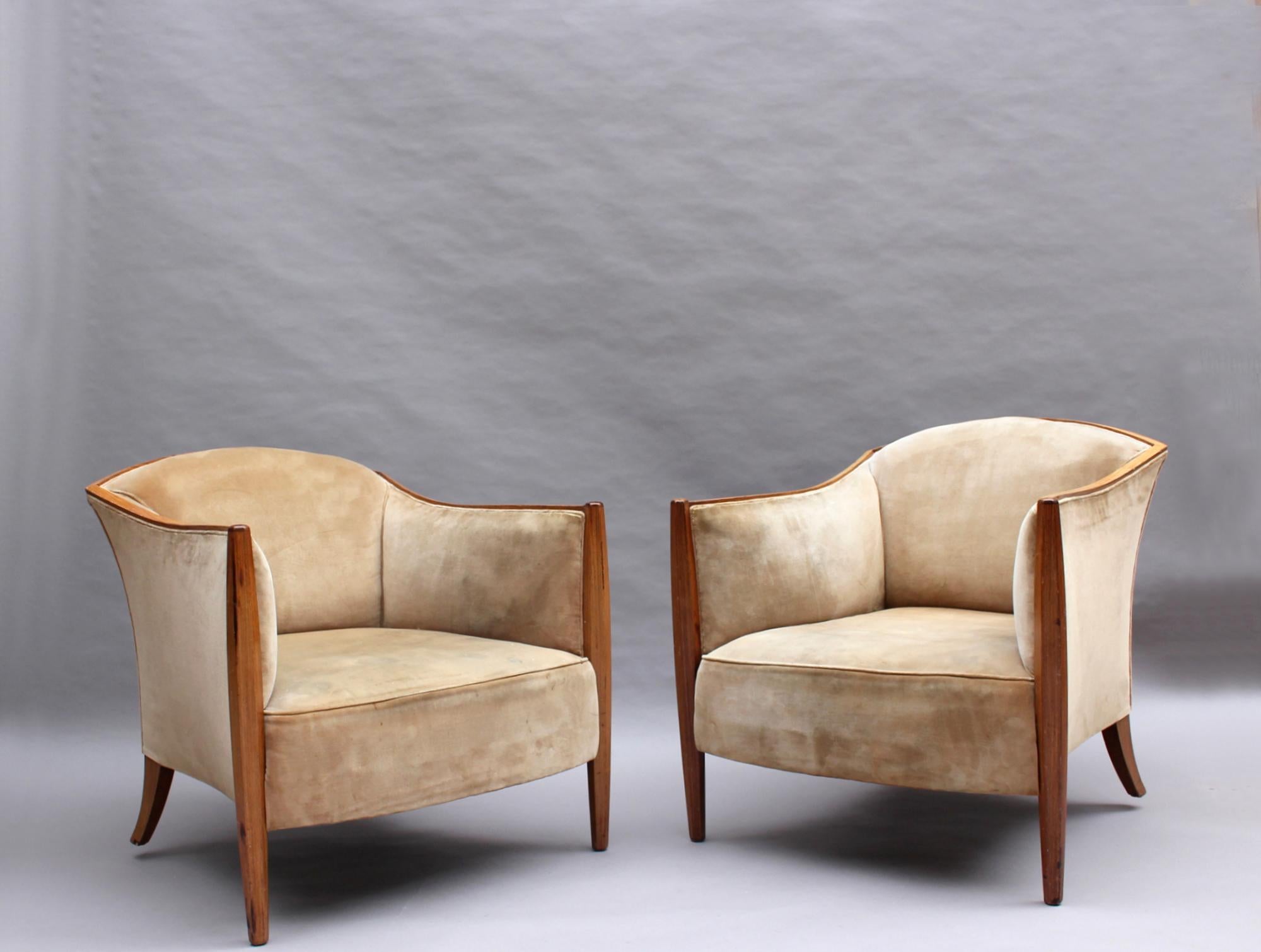 A pair of fine French 1930s upholstered lounge chairs with a palisander frame.