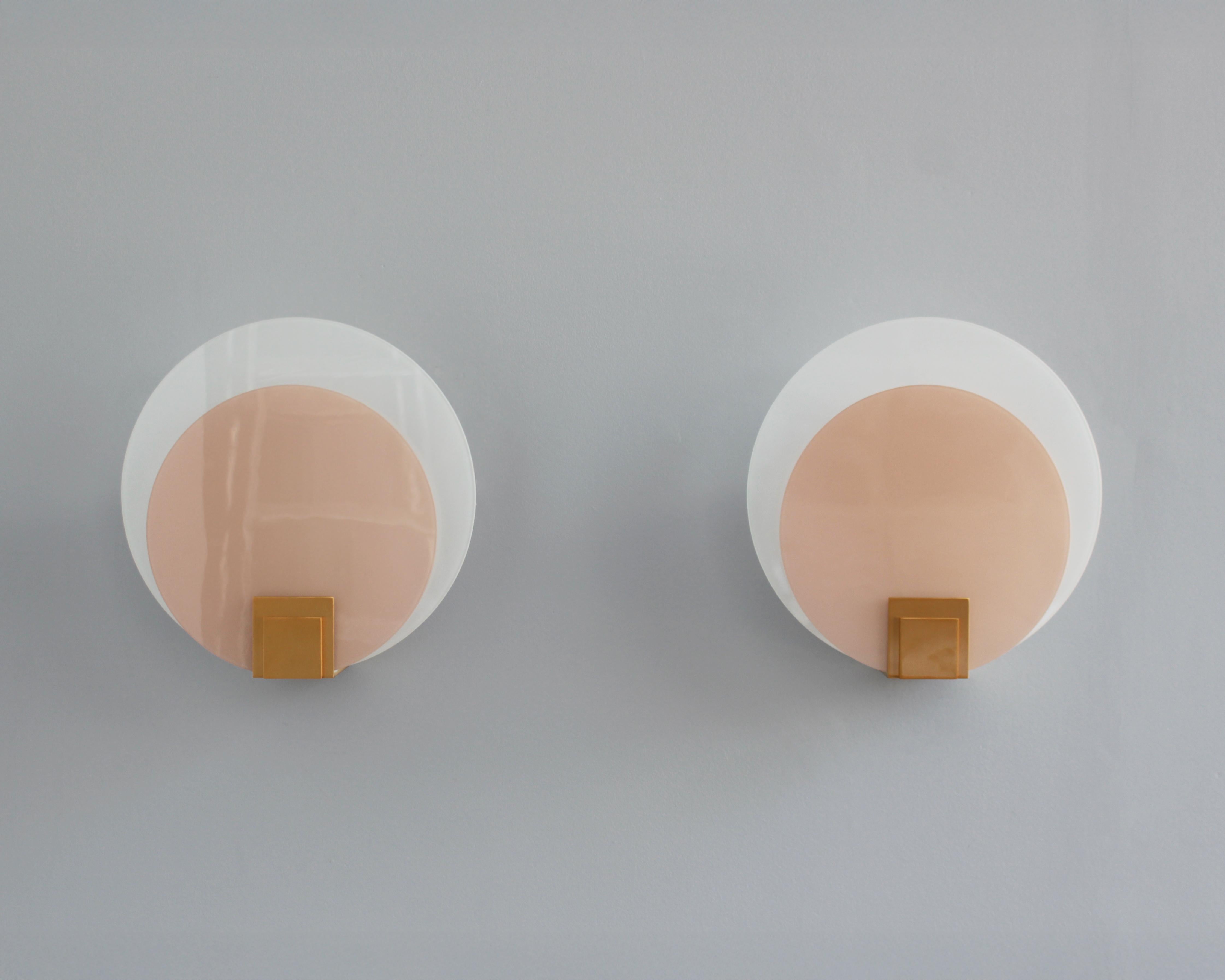 A pair of fine French Art Deco round sconces with enameled and frosted glass shades mounted on a re-polished bronze base.
Model created in 1926

