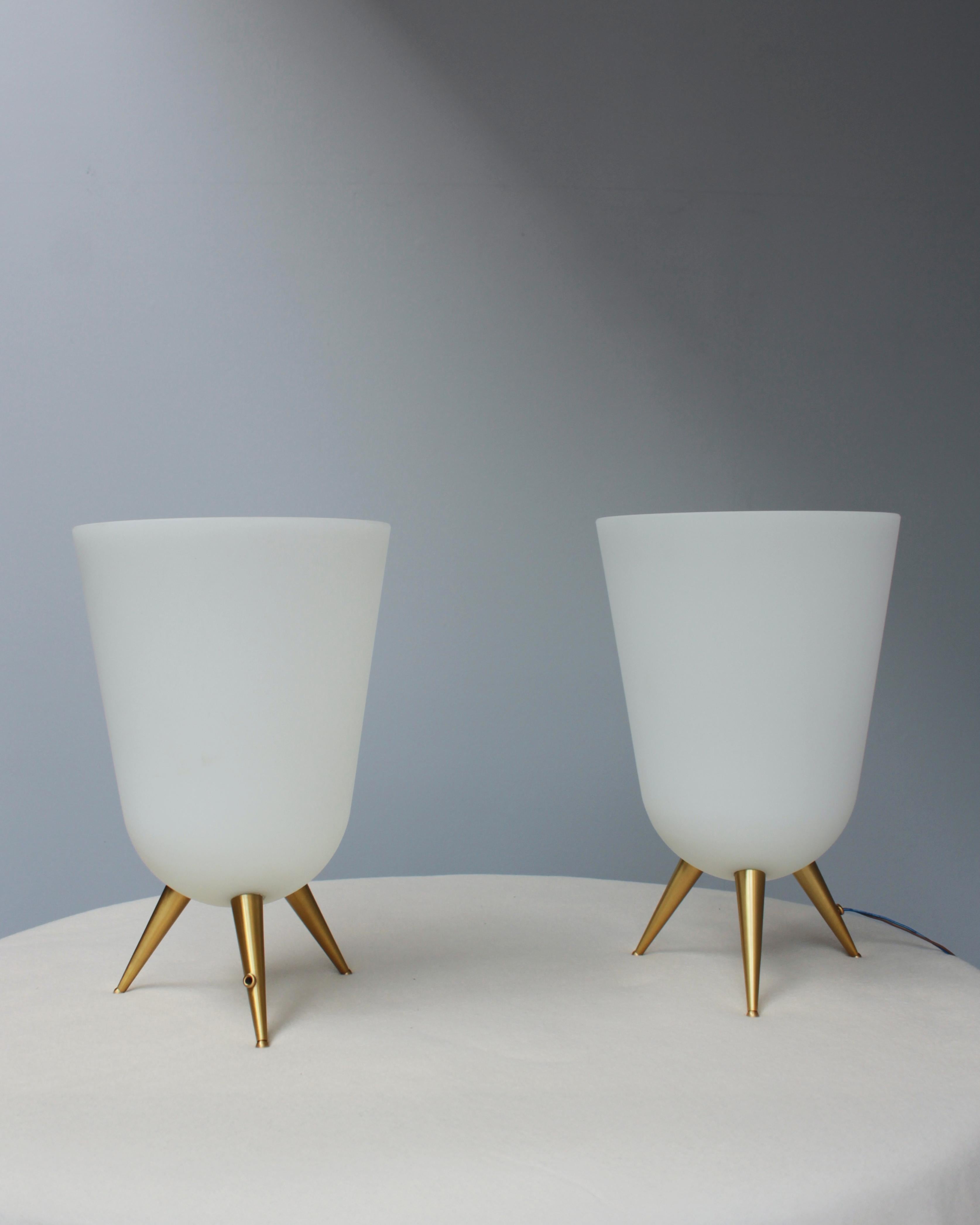 A pair of rare fine French 1950's table lamp by Jean Perzel with a frosted  white glass bowl attached on three bronze legs.

Re-wired.

Bibliography: Jean Jacques Wattel, 