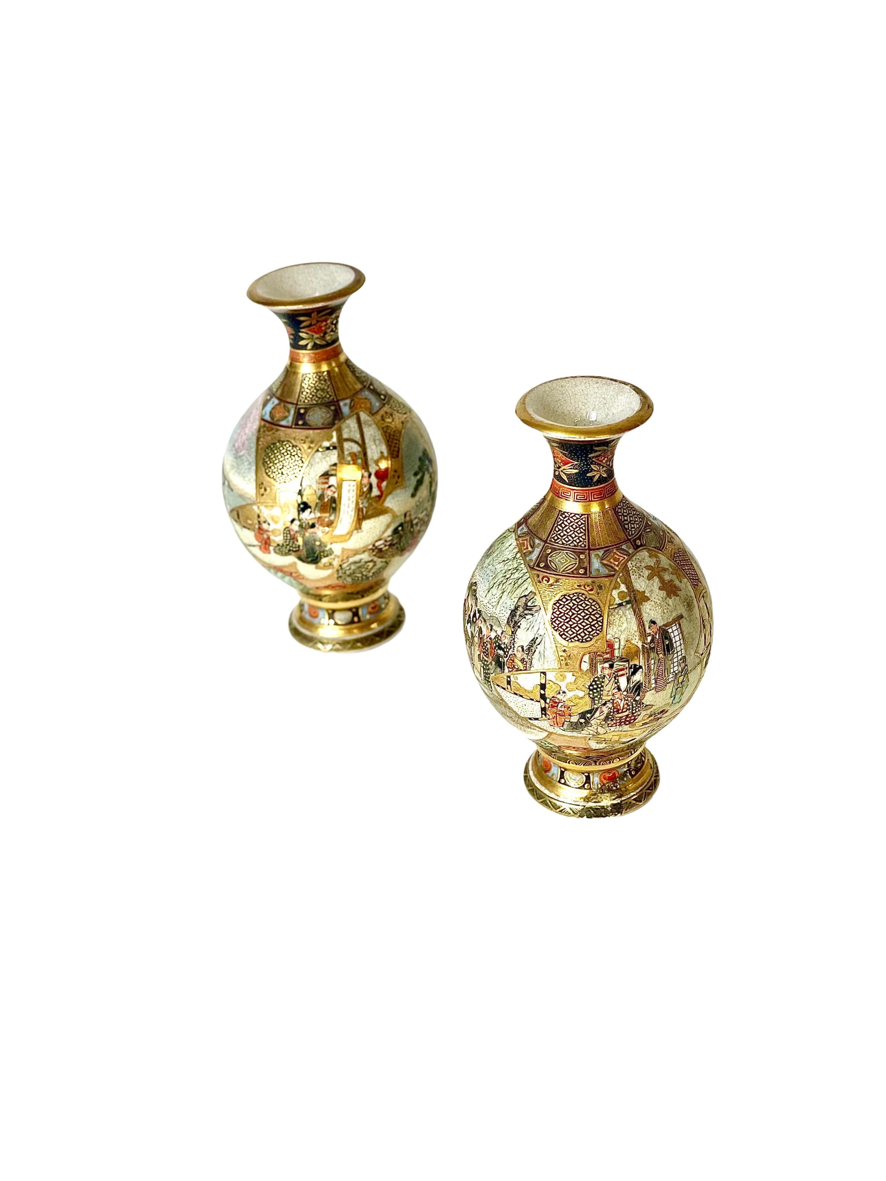 A fine pair of late 19th century Japanese earthenware Satsuma baluster vases, richly decorated with raised gilt work. These miniature vases feature figures in traditional dress playing out animated scenes within variously shaped reserves on each