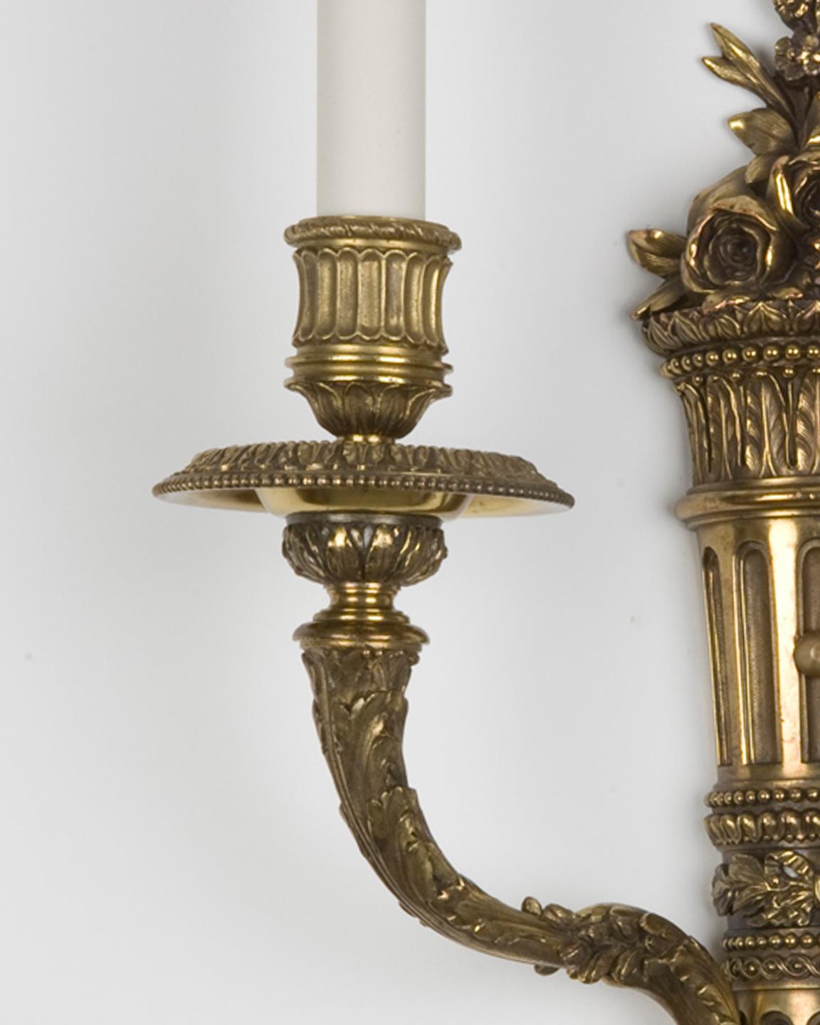 Neoclassical Cast brass two arm sconces with foliate details by E. F. Caldwell Co. Circa 1900 For Sale