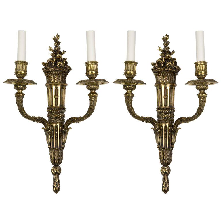 Cast brass two arm sconces with foliate details by E. F. Caldwell Co. Circa 1900