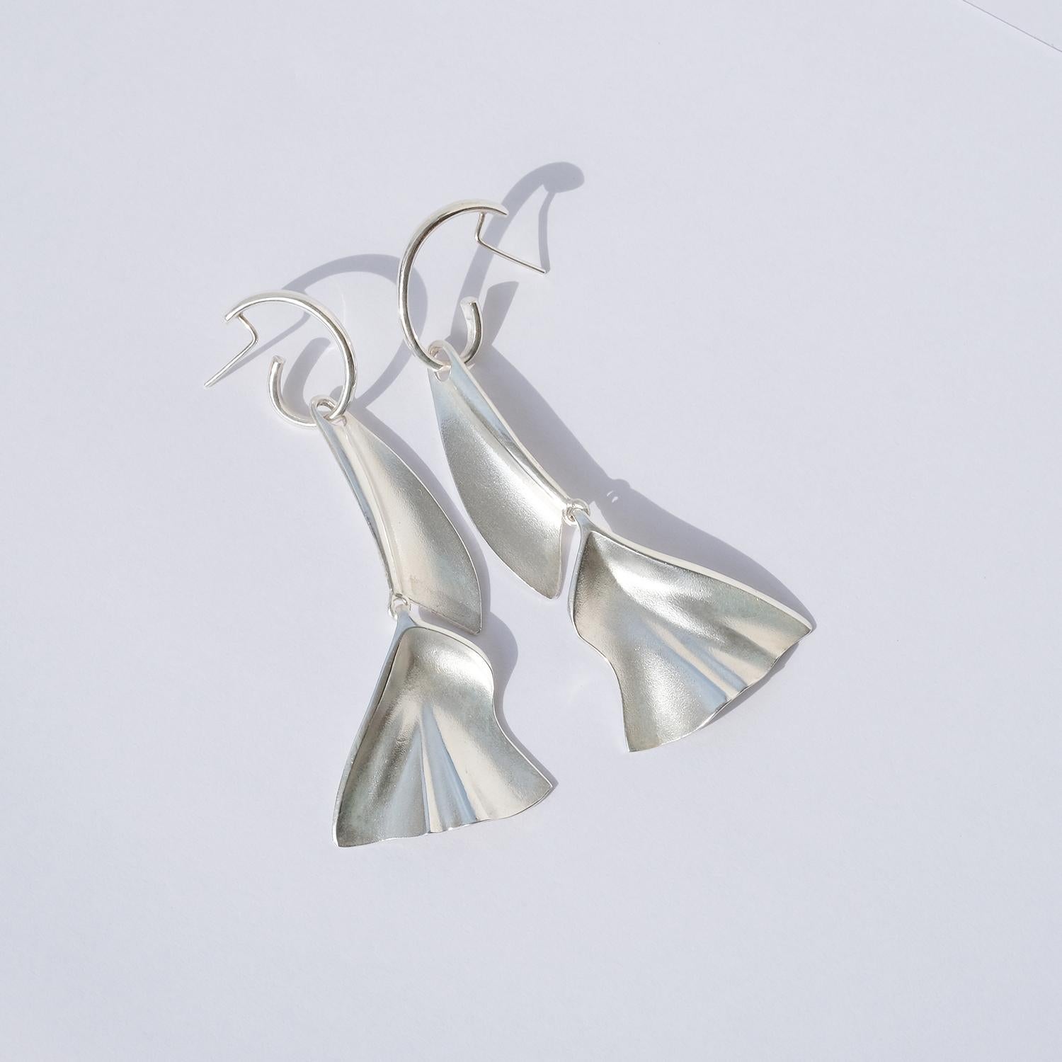These sterling silver earrings have a brusched, bright and matte surface. The earrings are divided into two parts making them dangle in an appealing way.

The earrings reseamble native american feather earrings, and these versatile pieces can accent