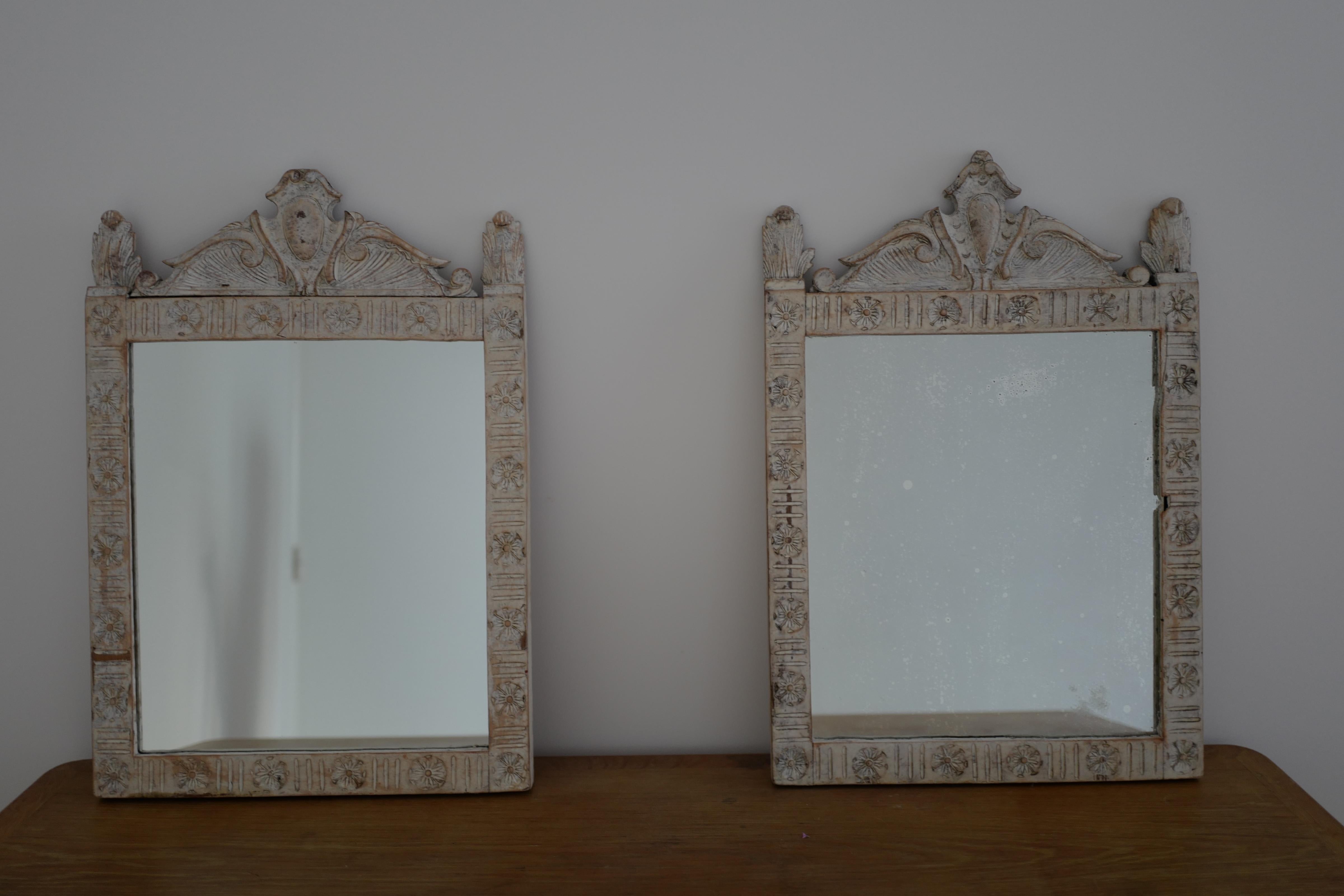 A pair of 18th century Italian Firenze painted gilt wood mirrors in white. Original mercury glass in one. New glass in the other as the others original glass sadly did not make it. Beautiful and rare pair.
