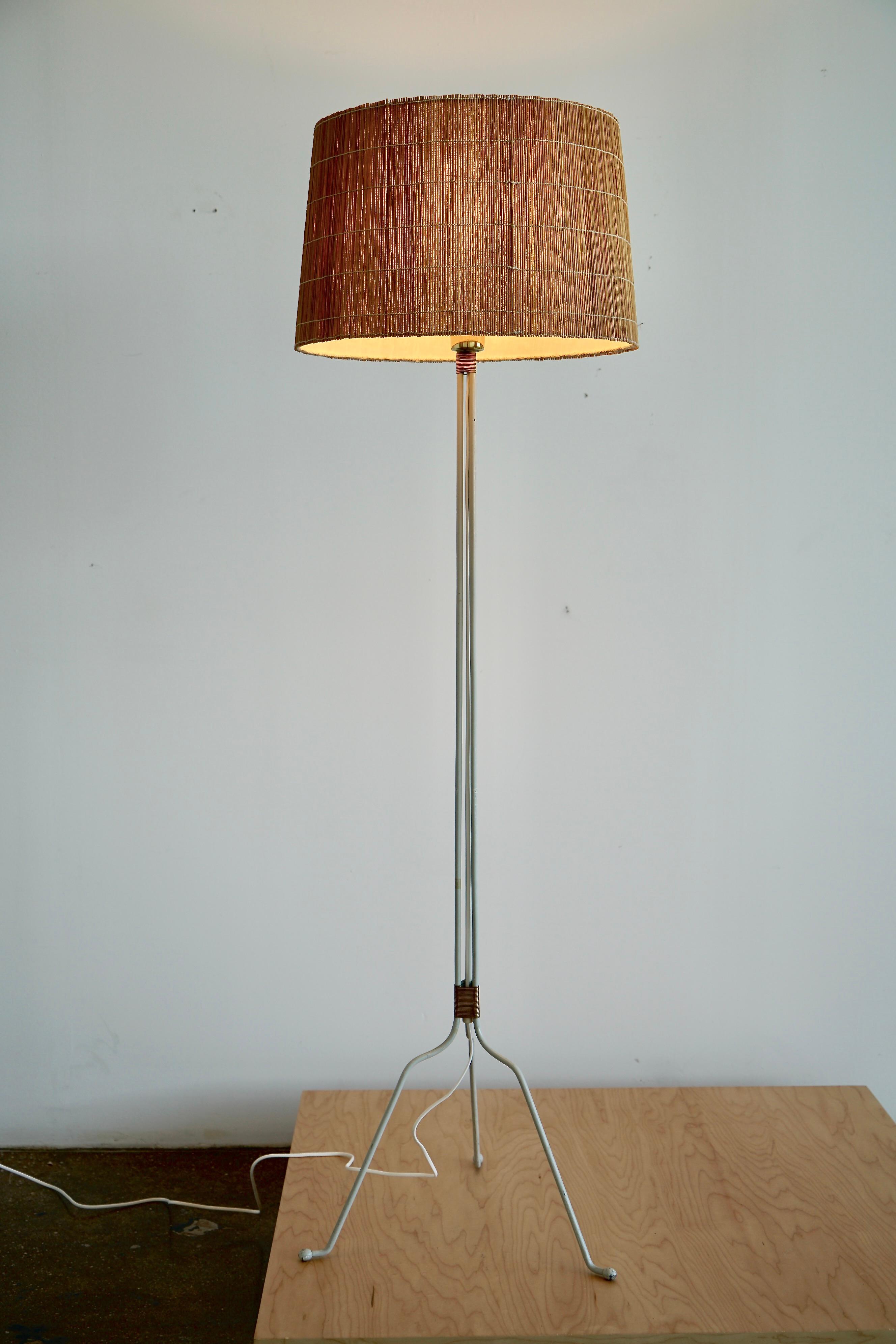 A pair of rare mid century floor lamps designed by Lisa Johansson Papé produced by Orno Oy in Finland 1940s. Model 30-058. In good original condition with later made  pine straw shade. Can be sold individually .
H 61″; Diam 17″. The shade H 11″;