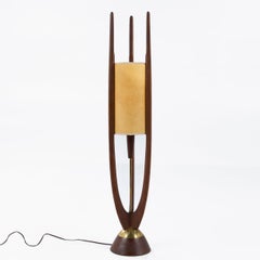 A pair of floor lamps in walnut by John Keal