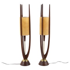 A pair of floor lamps in walnut by John Keal