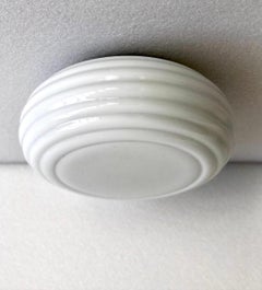 A pair of flush mount fixtures by Paavo Tynell
