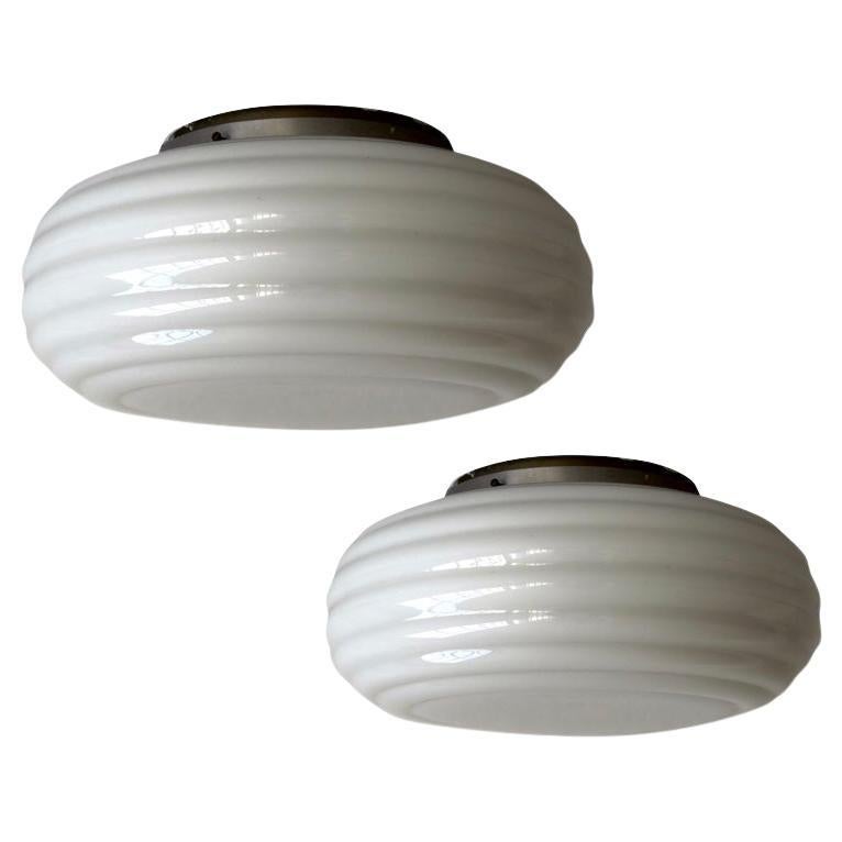 A pair of flush mount fixtures by Paavo Tynell